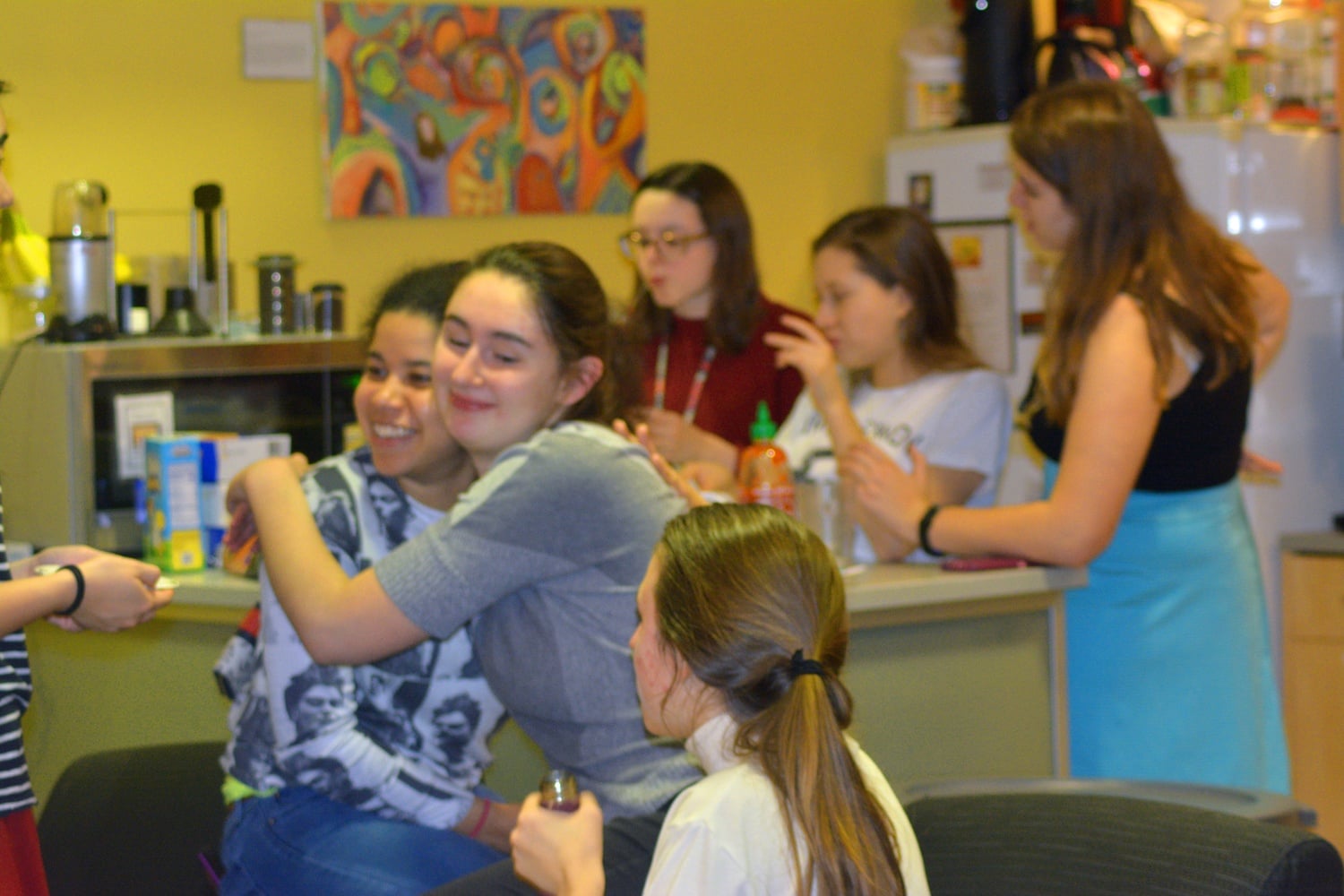Students embrace at the First Year Mixer at the Harvard College Women’s Center Wednesday evening. At this mixer, freshmen learned about the different resources that the Women’s Center offers.