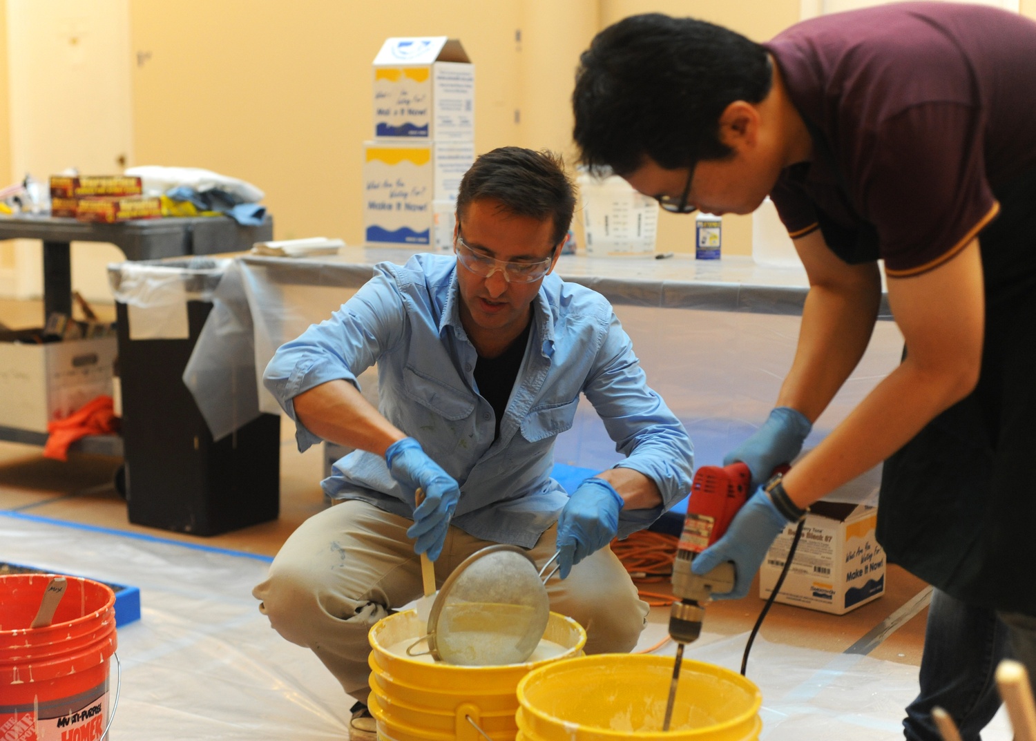 Adam J. Aja, the assistant curator of collections at the Harvard Semitic Museum, demonstrates proper sieving technique for the production of plaster casts. Aja and his team worked to cast the “Dream Stele” of King Thutmose IV.