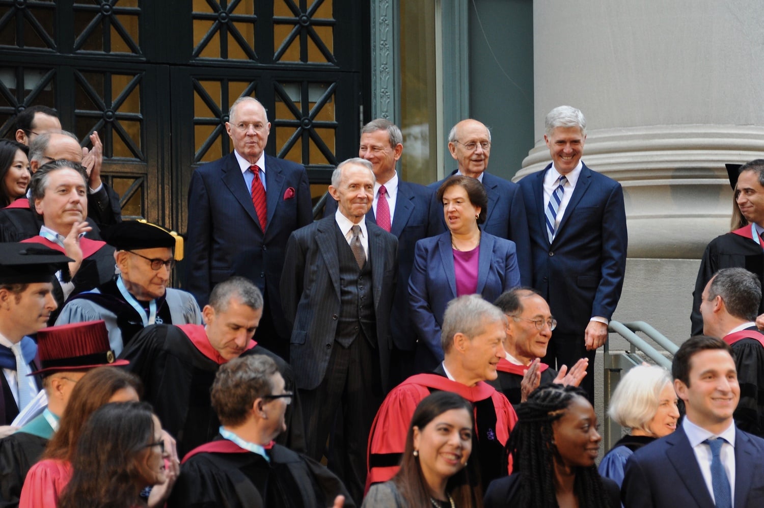 US Supreme Court Associate Justice Anthony M. Kennedy, Chief Justice John Roberts '76, Associate Justice Stephen G. Breyer, and Associate Justice Neil M. T. Gorsuch (top row from left) stand for a photo in front of the Harvard Law School Library Thursday afternoon. Retired Associate Justice David H. Souter and Associate Justice Elena Kagan stand in the row before them.