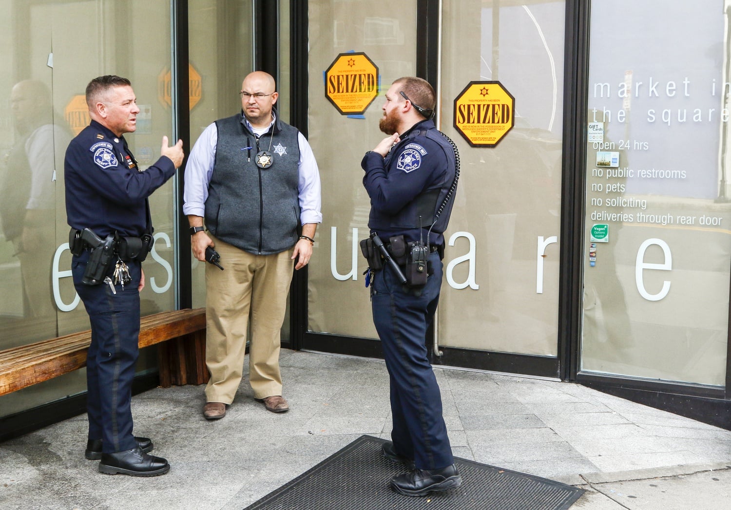 Officers from the Middlesex County Sheriffs Office stand outside Market in the Square on Thursday afternoon.  