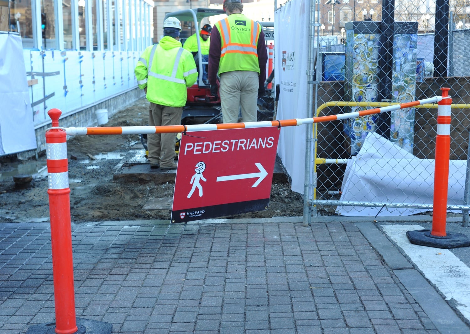 A sign warns pedestrians of the ensuing construction near Harvard Square.
