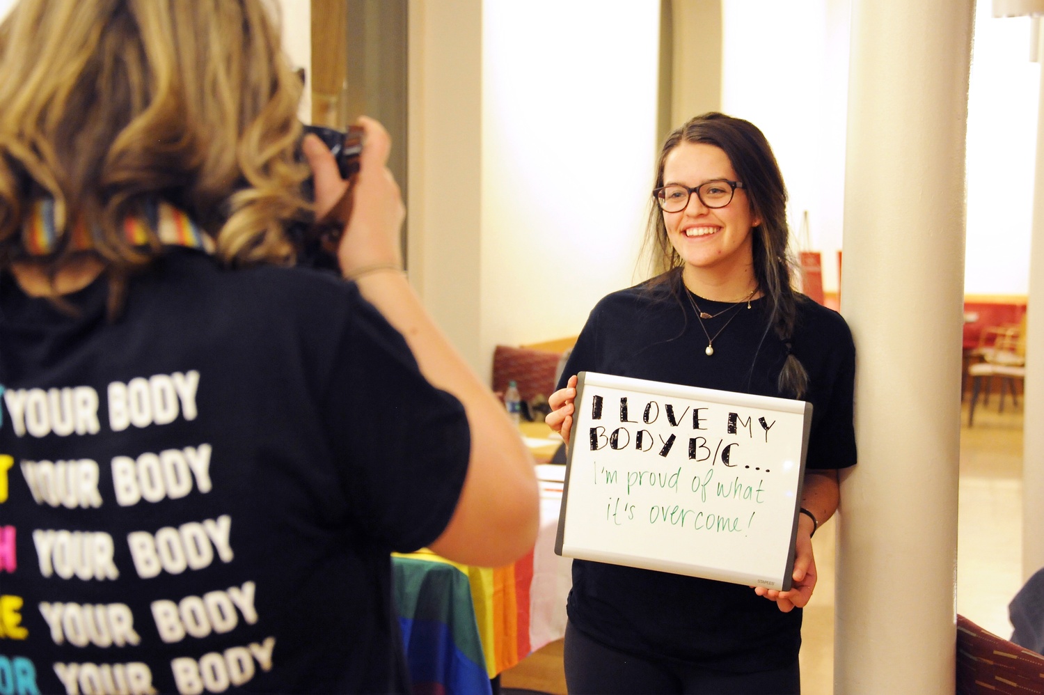 Cassandra S. Hastie '18 takes a photo of Karen M. Maldonado '18 during ECHO's "Love Your Body Day" event in Ticknor Lounge Thursday evening. Hastie and Maldonado are both ECHO peer counselors.