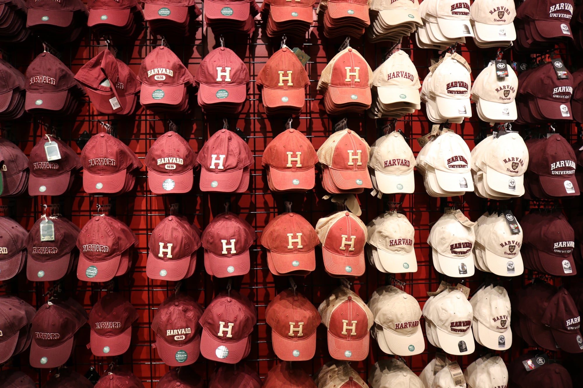 A wide variety of hats line the walls of the Harvard Shop. 