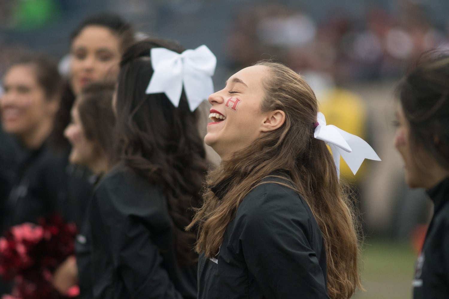 Cheerleader Audrey Green '19 laughs on the sidelines.