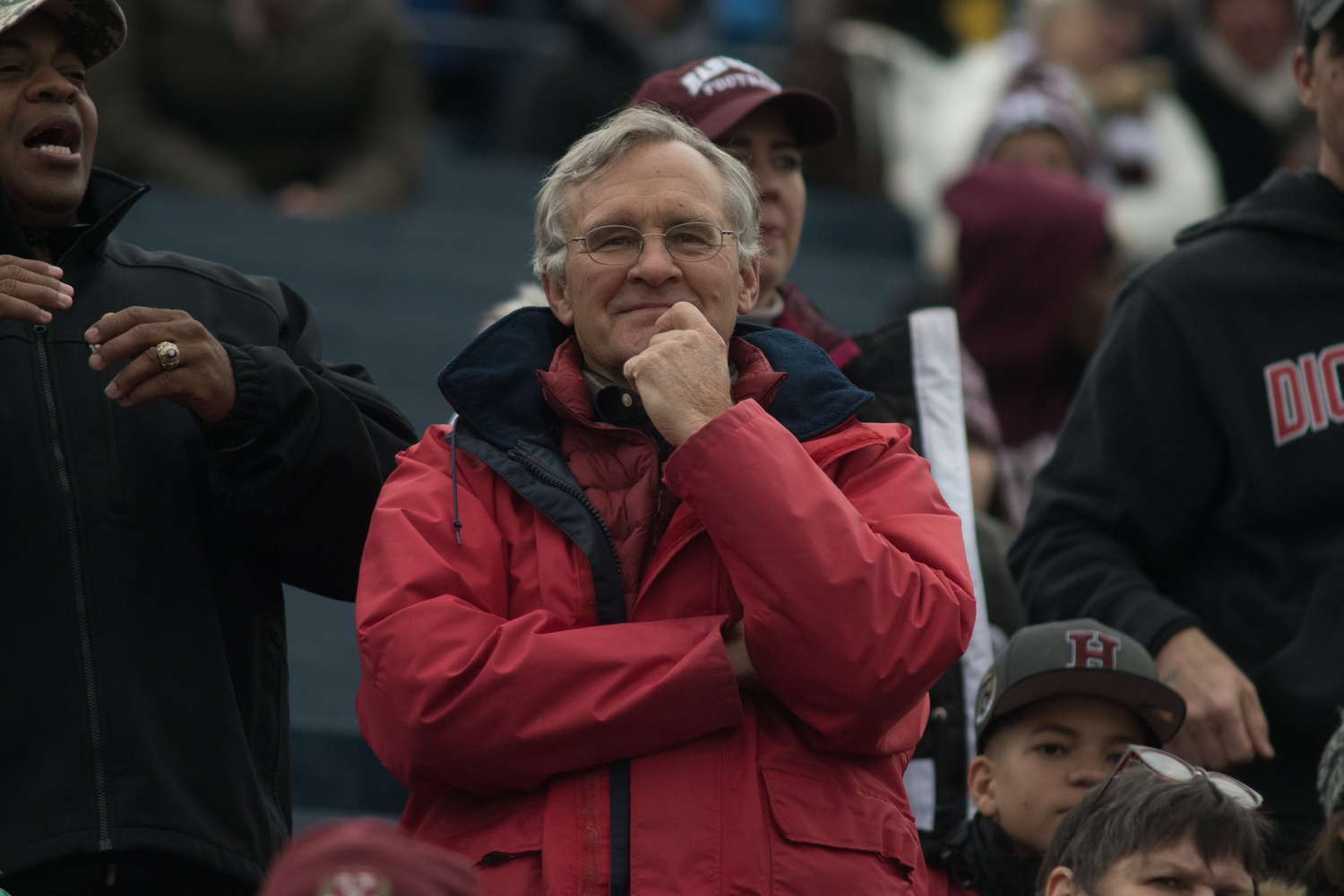 A fan watches intently from the Harvard Alumni section.