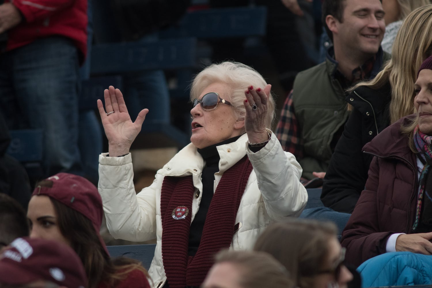A fan claps for Harvard as the deficit to Yale grows. 