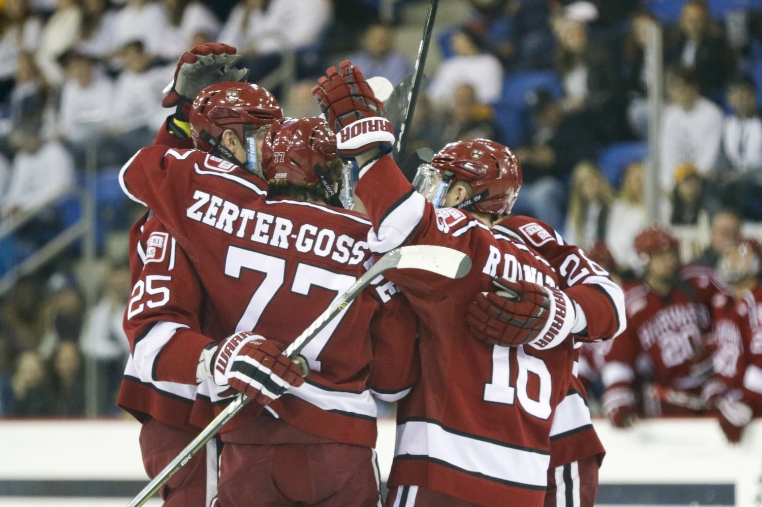 The team celebrates its first goal of the evening as senior blue-liner Wiley Sherman finds nets a slapshot from the point. The strike was the first of three opening-period tallies for the Crimson.