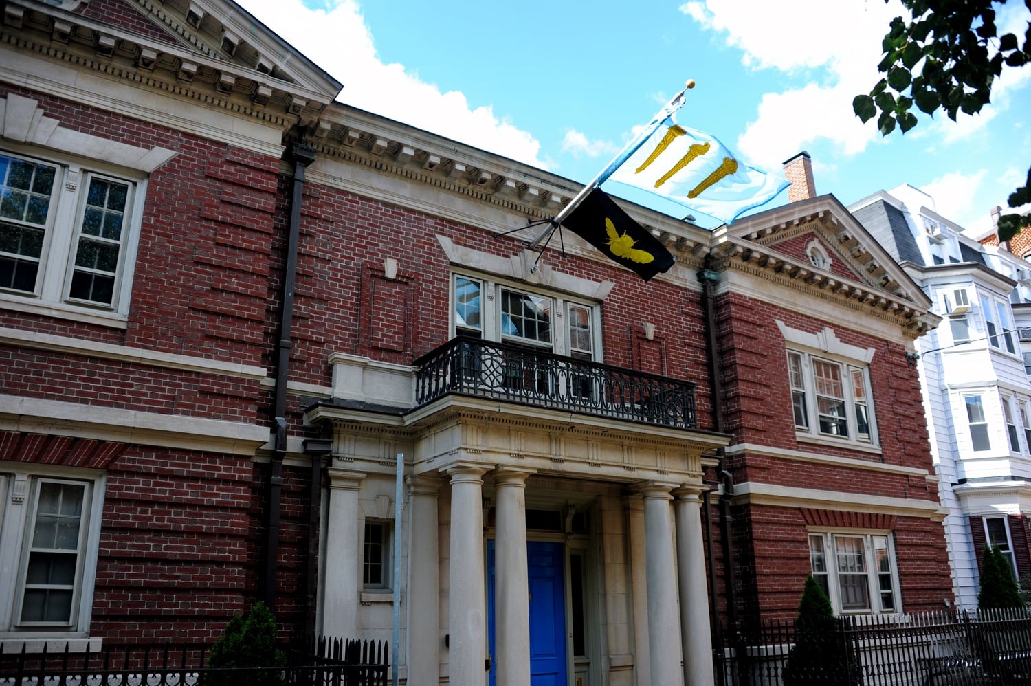 The flags of the Bee and the Delphic Clubs fly outside the clubhouse on Linden St. historically owned by the Delphic.  The two clubs have shared their membership and clubhouse since Sept. 2017.