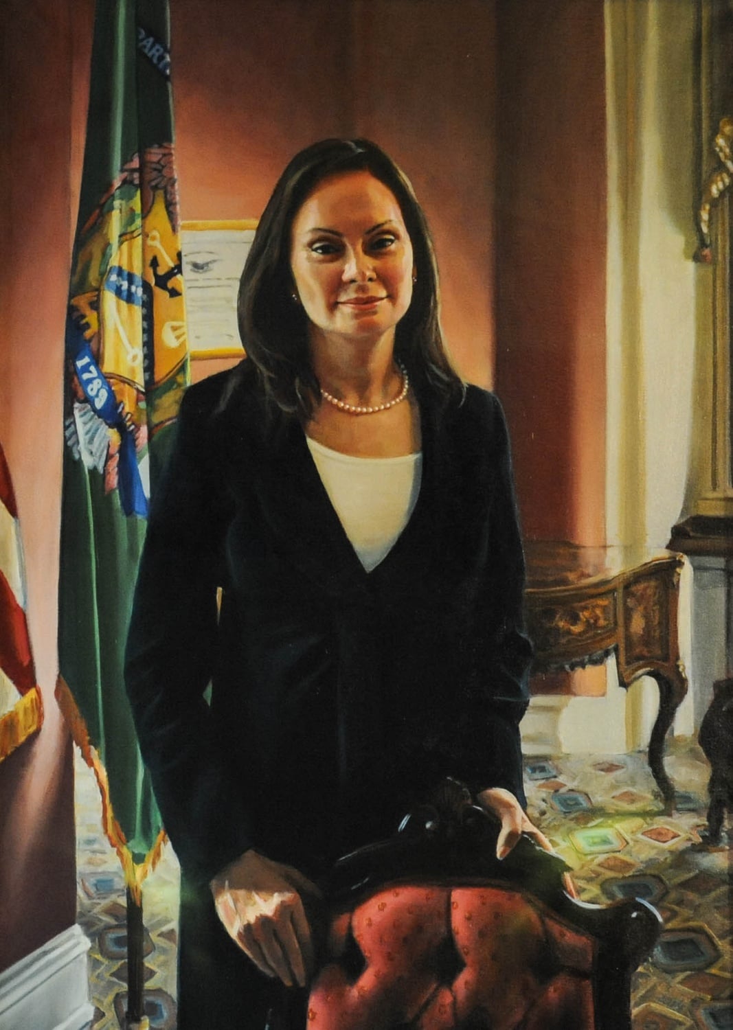 A portrait of Rosa "Rosie" Gumataotao Rios '87, the 43rd Treasurer of the United States, hangs on the wall in the Junior Common Room of Winthrop House. The portrait is one of many painted by artist Stephen E. Coit '71 displayed around campus.