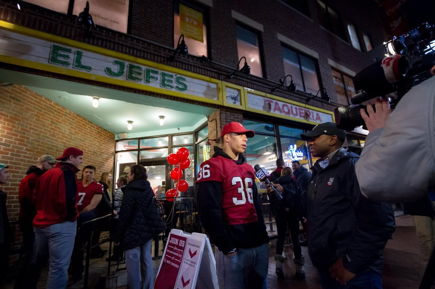 Tanner J. Lee '18, a safety on the football team, speaks to local newscasters outside El Jefe's Taqueria during the fundraiser in aid of Ben M. Abercrombie '21, who suffered a catastrophic injury during a game earlier this semester.