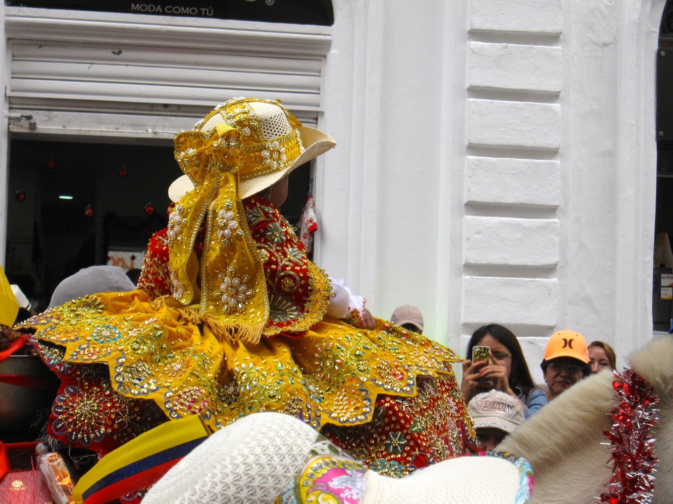 A small girl rides a lavishly decorated horse in Cuenca’s Pase del Niño parade. Adults as well as children go all out for the parade, dressing as angels, Santa Claus, or figures from the Bible, or wearing clothing from different regions of Ecuador and the world.