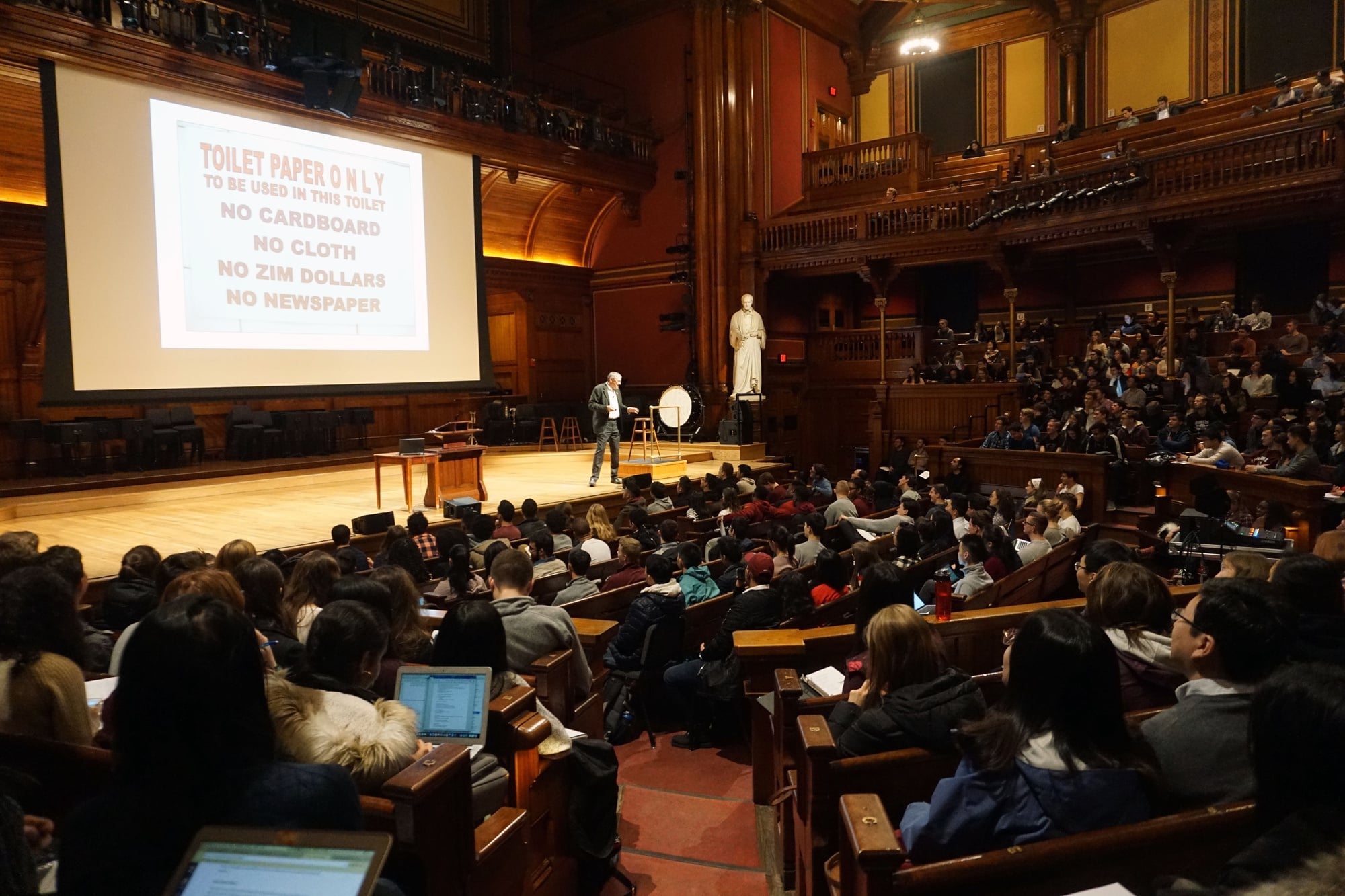 Professor N. Gregory Mankiw discusses the inflation of Zimbabwe dollars at the first lecture of Economics 10B: Principles of Economics in Sanders Theatre.