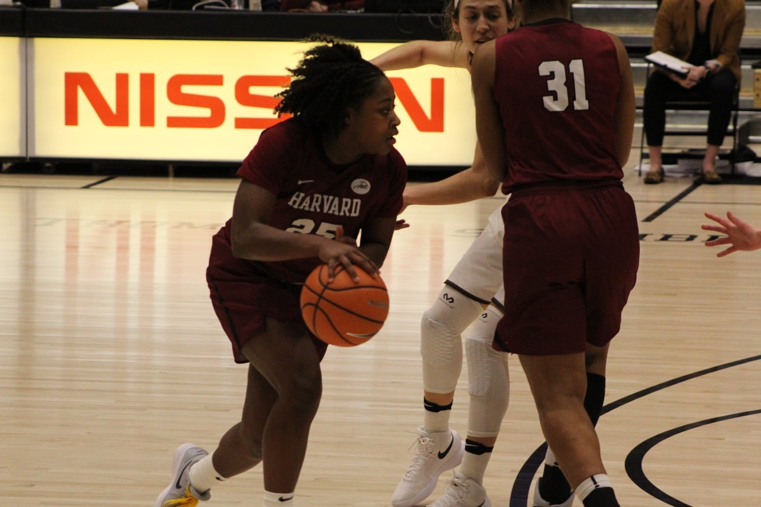 Junior guard Sydney Skinner dribbles around a screen set by senior Taylor Rooks.