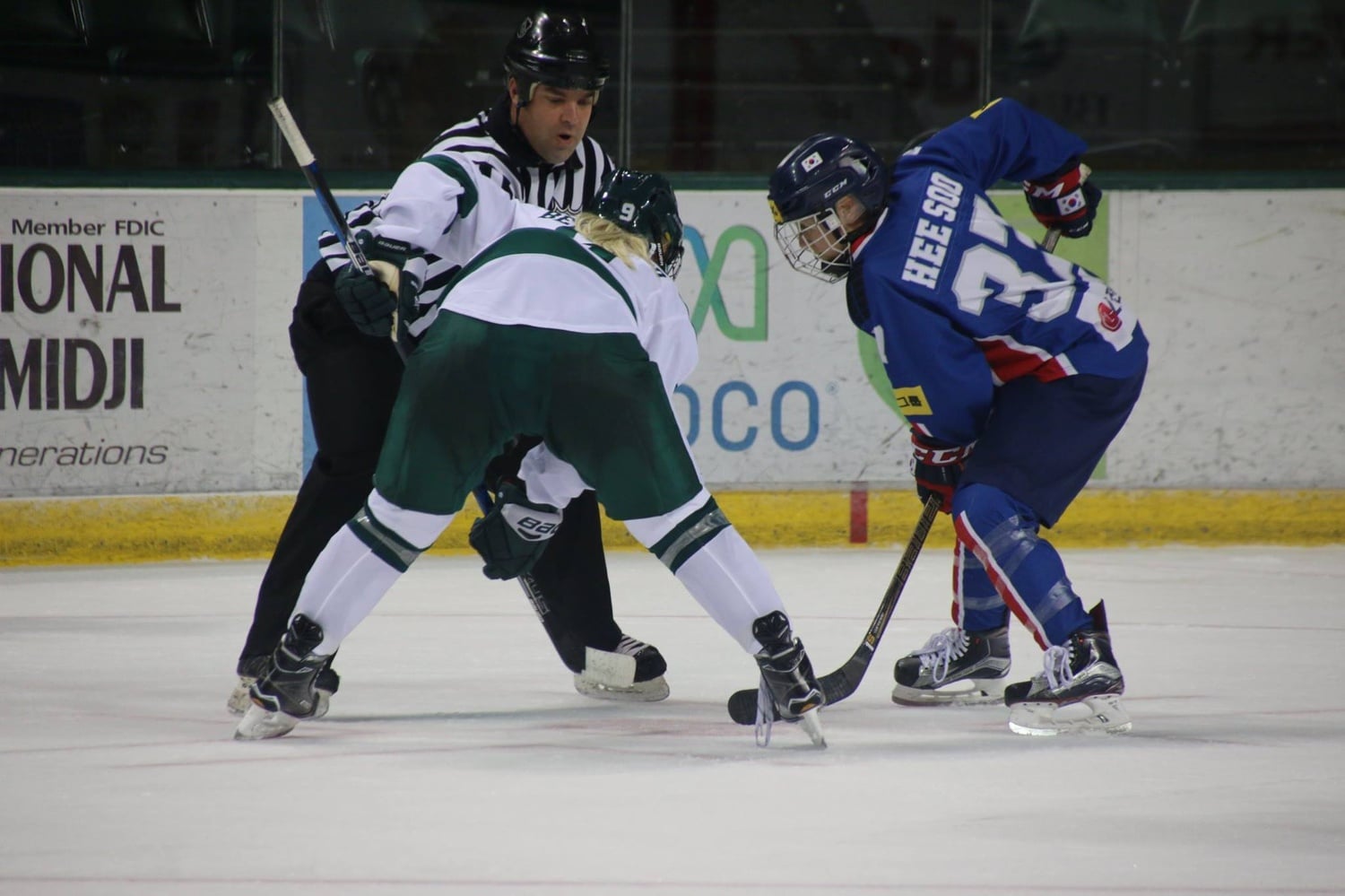 Randi Griffin faces off with another hockey player.