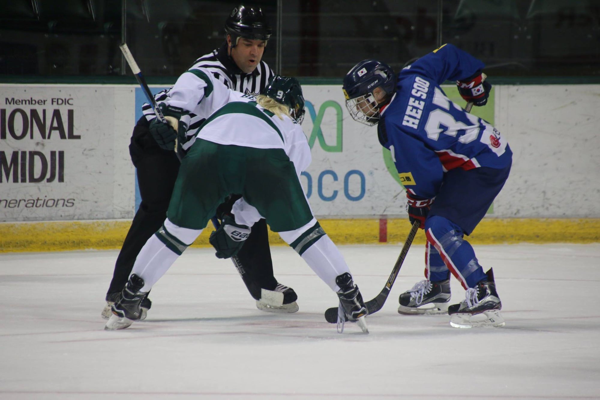 Randi Griffin faces off with another hockey player.