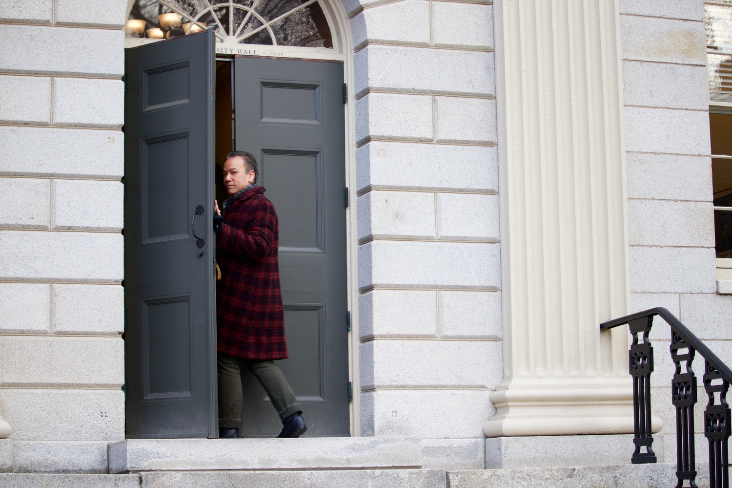 Robert A. Lue, molecular and cellular biology professor and HarvardX faculty director, enters the faculty meeting on Tuesday .