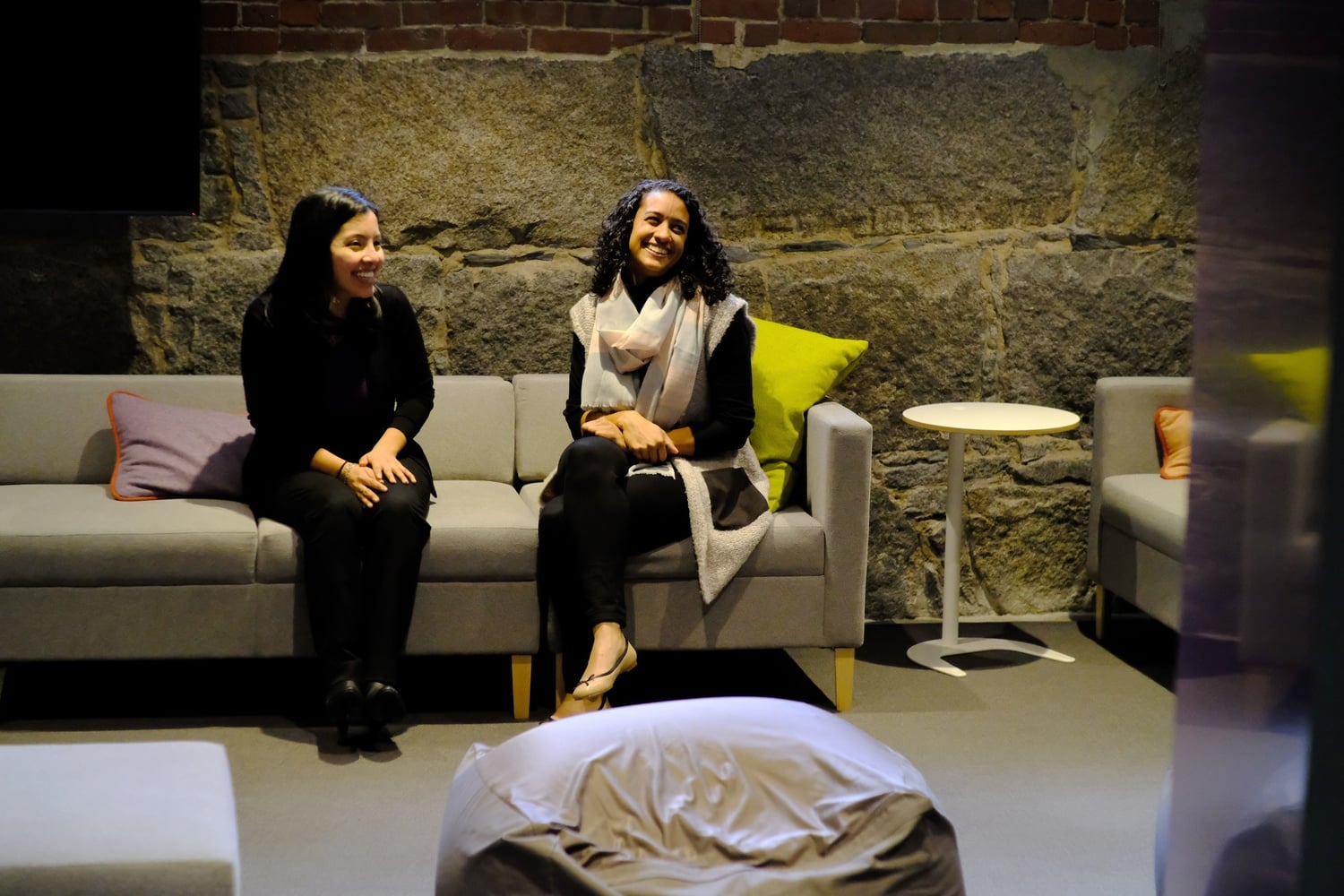 Grace Montero and Ileana Casellas-Katz relax in the common space outside of their office in the newly renovated basement of Grays Hall.