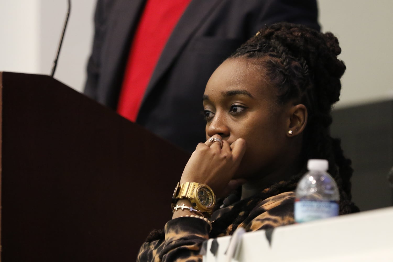 Jackie Hill-Perry listens as Reverend Jonathan L. Walton speaks at religious group Harvard College Faith and Action's meeting Friday night. Some students criticized HCFA's decision to invite Hill-Perry, an outspoken critic of homosexuality.