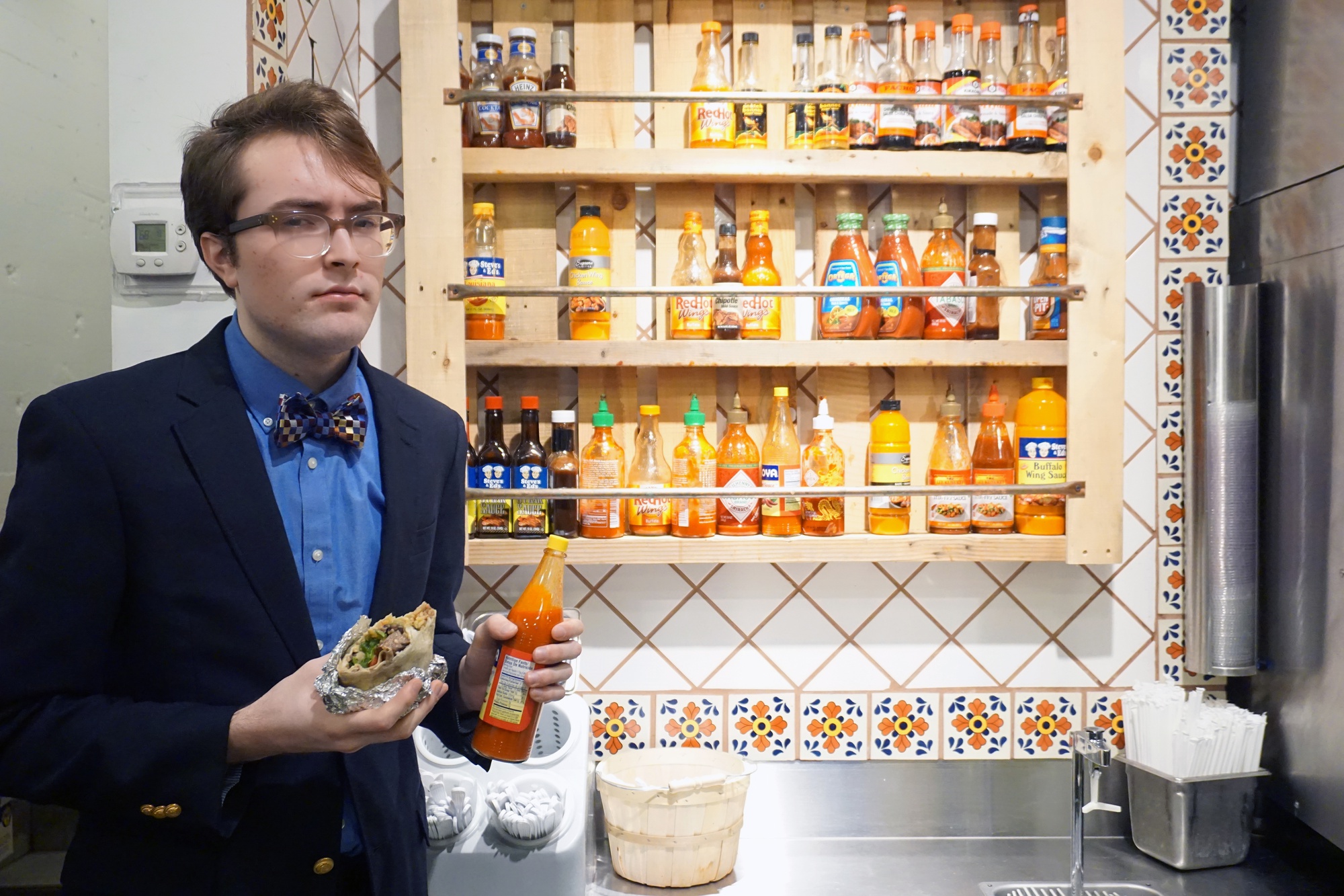 Prominent author "T.S. Eliot" (FM writer Drew Pendergrass) adds hot sauce to his burrito at El Jefe's.