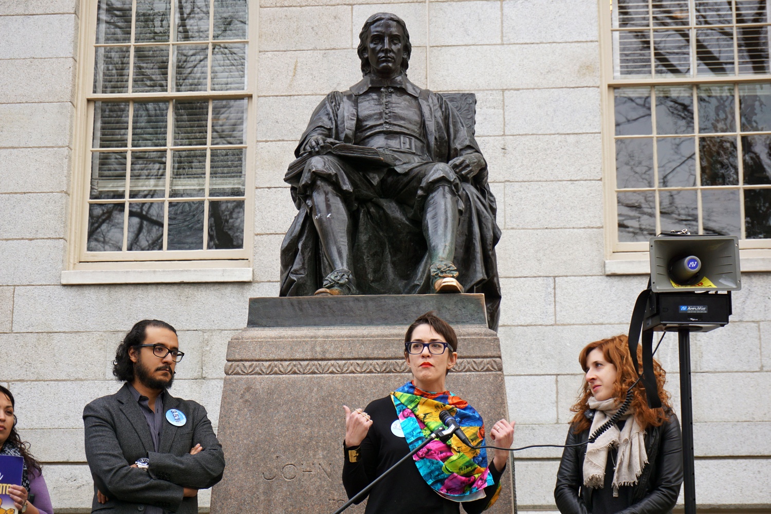 People gather in front of the John Harvard statue to rally for immigrant residents with Temporary Protected Status. 