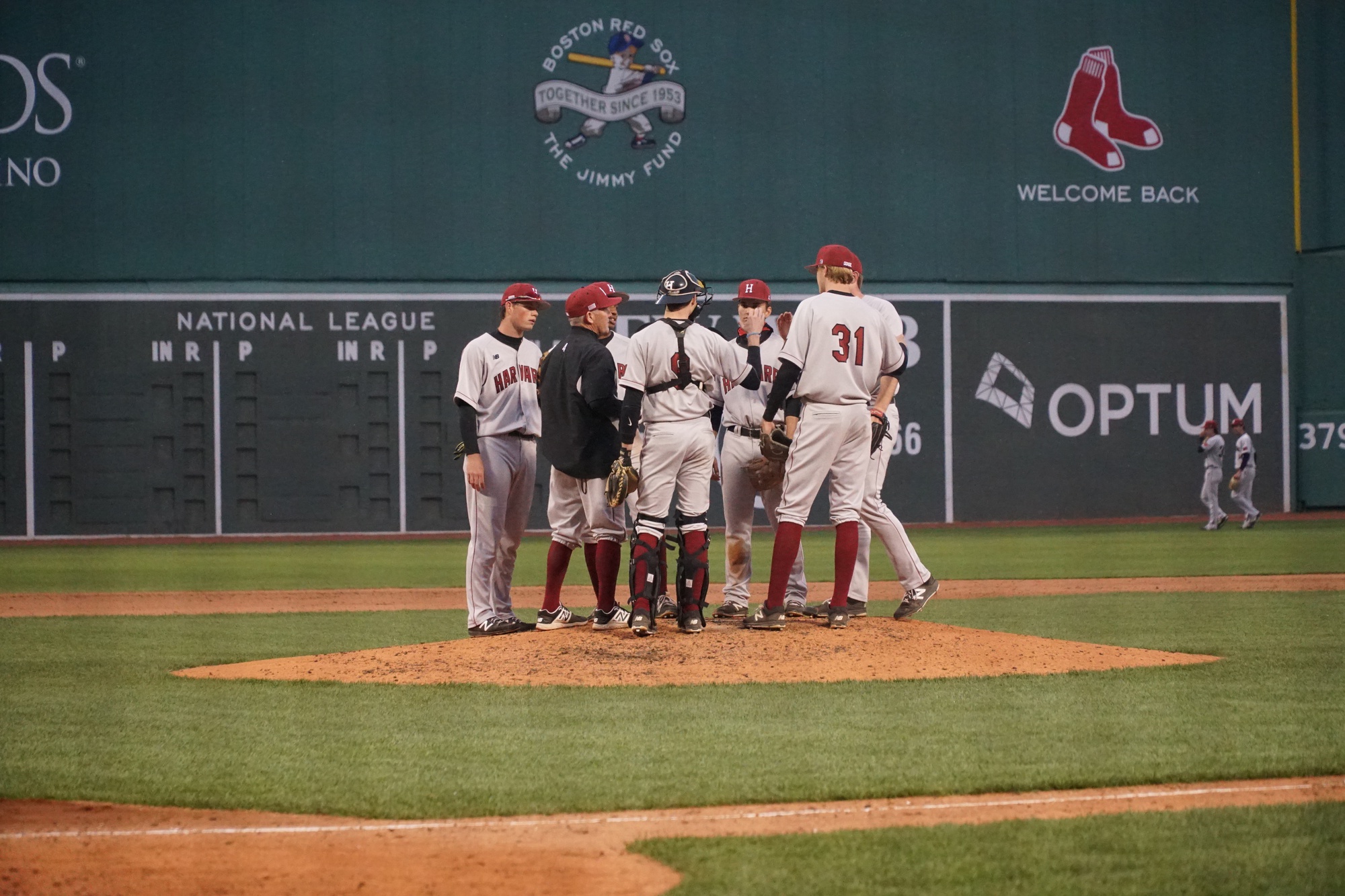 The infielders and coach of the Harvard baseball team gather at the pitcher’s mound during last year’s Beanpot series