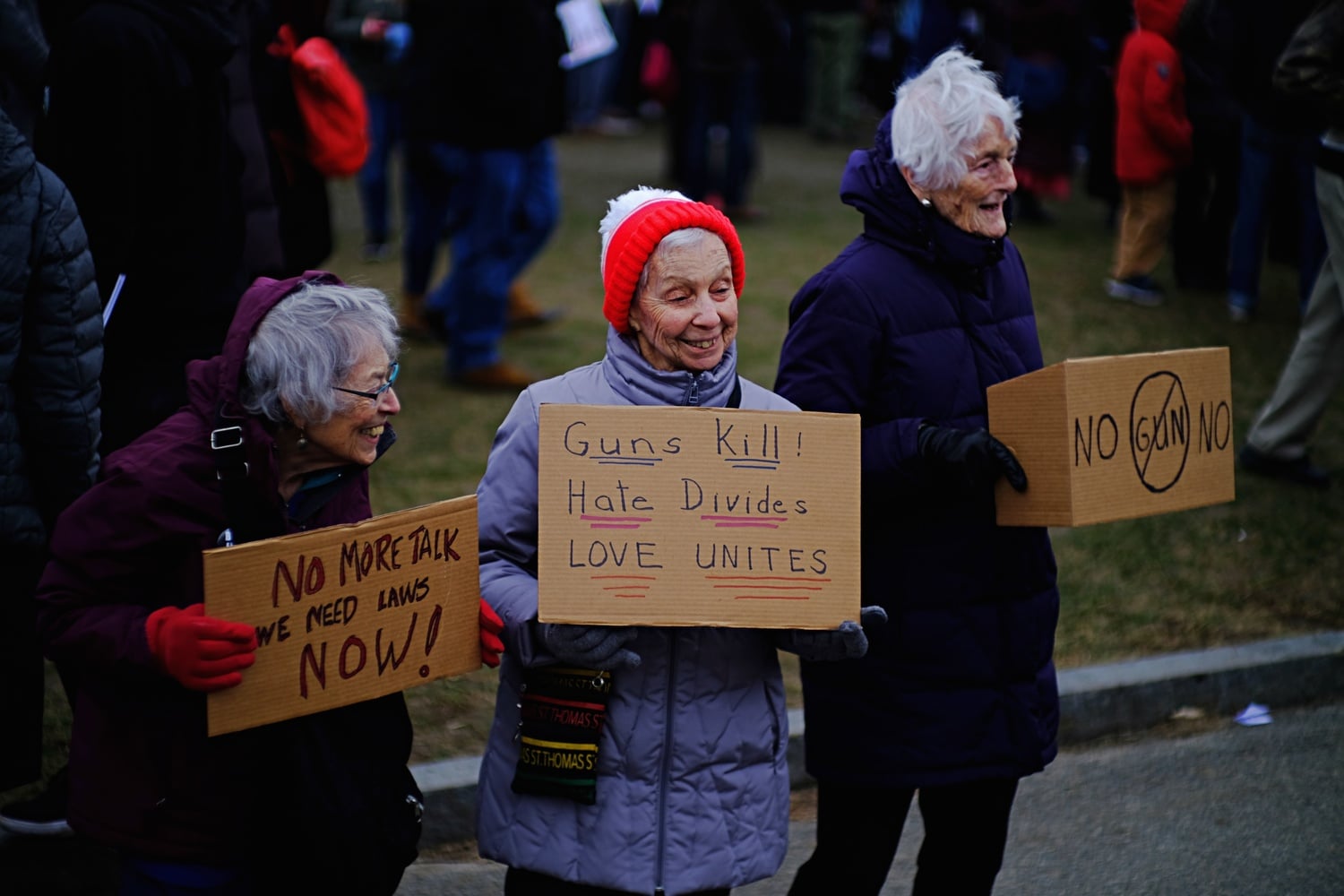 Protesters hold signs at the 2018 Boston iteration of the nationwide anti-gun violence March For Our Lives.