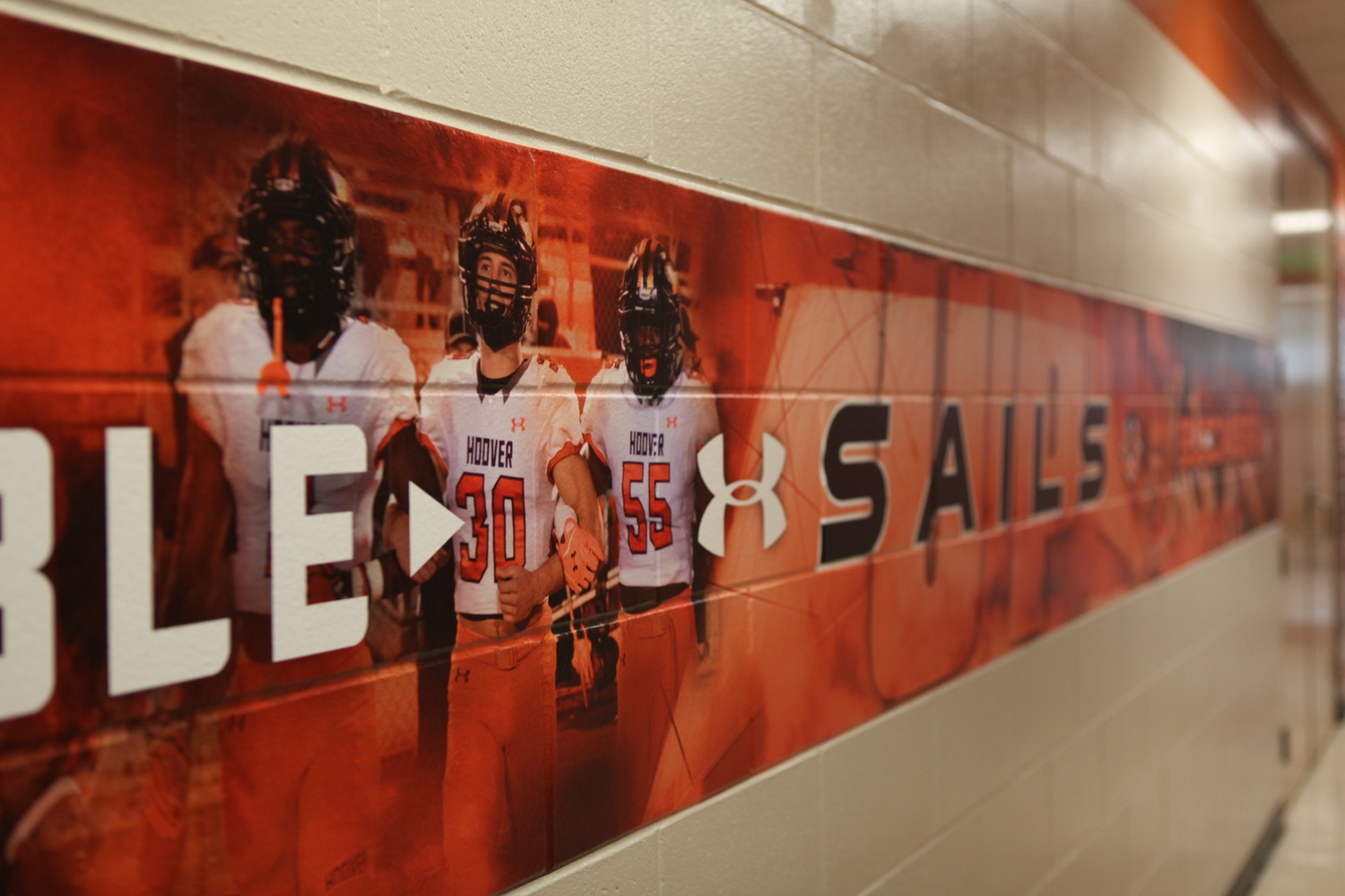 A mural of Ben M. Abercrombie '21 and his teammates covers a wall of his high school.