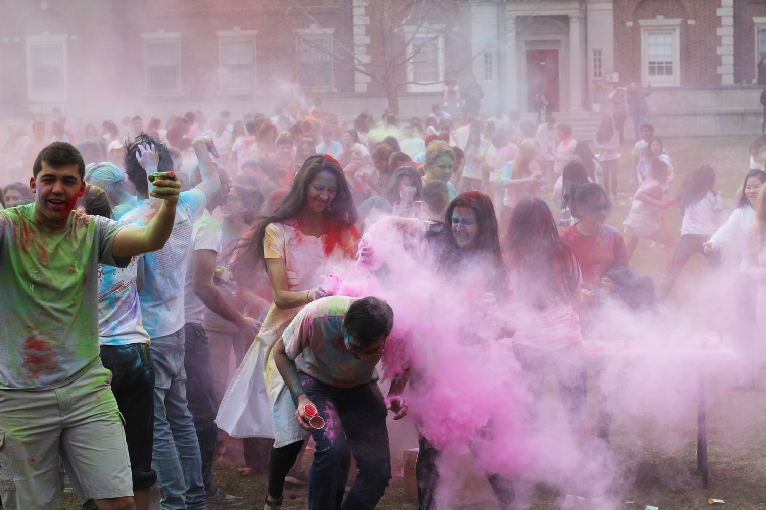 Students celebrate the Hindu spring festival of Holi on the Quad Lawn by throwing colored powder at each other Sunday afternoon.