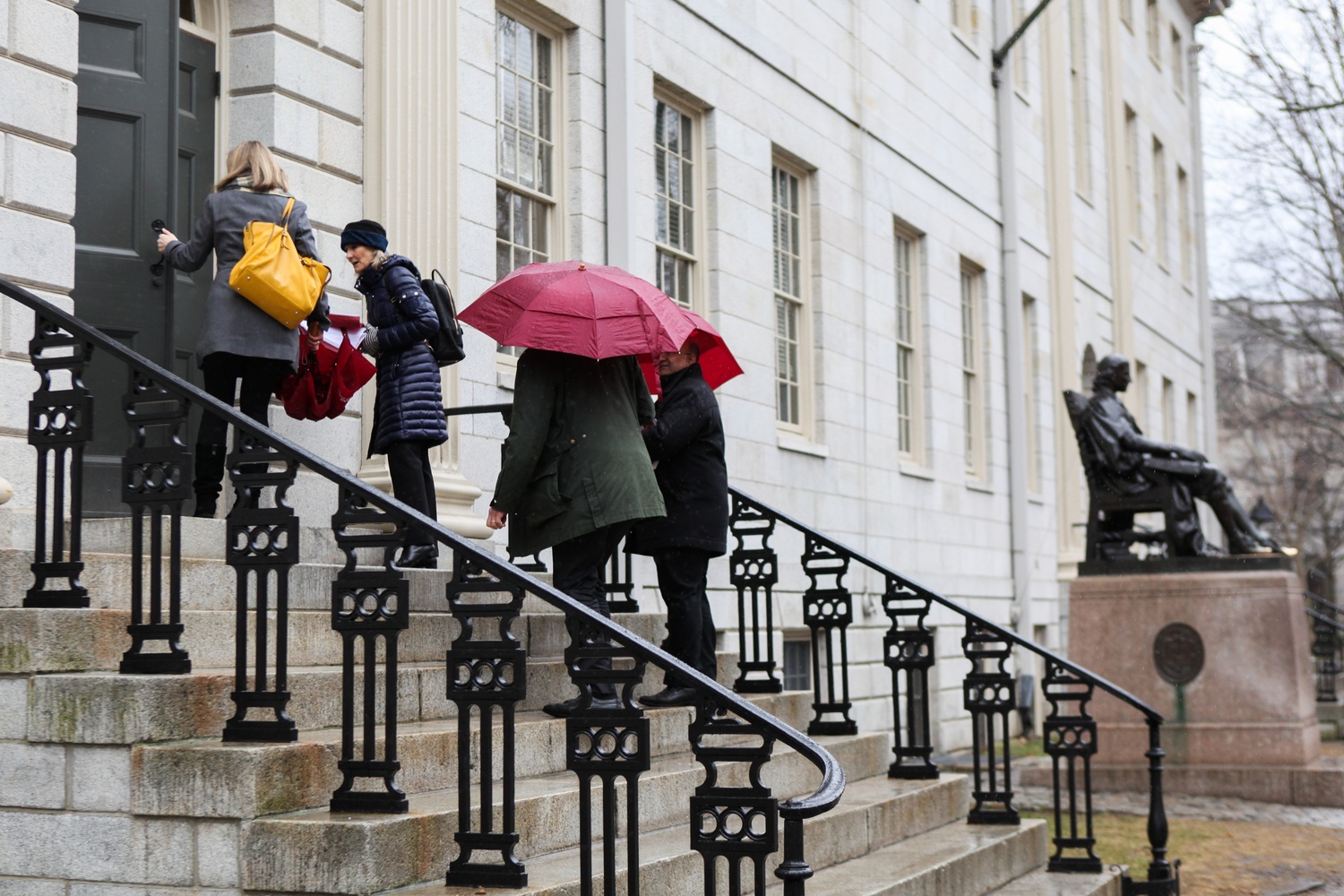 Faculty enter University Hall for their monthly faculty meeting on a rainy Tuesday afternoon in spring 2018.