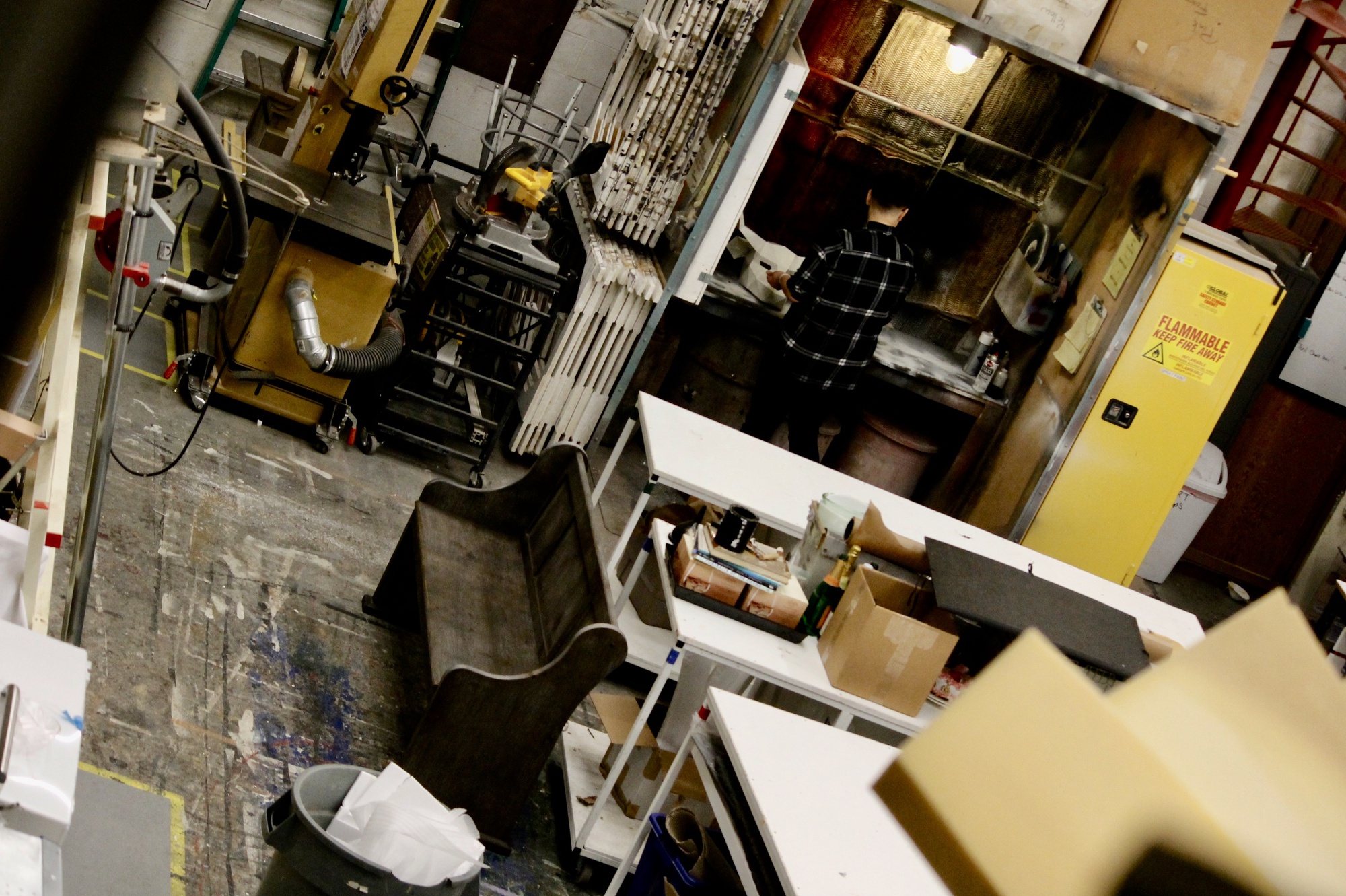 Kat T. Nakaji stands in the middle of the workshop at the American Repertory Theater.