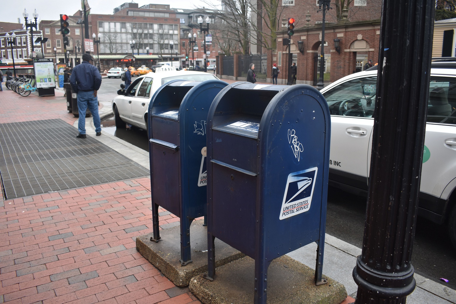 Two mailboxes stand on Massachusetts Avenue. Graduate research assistants away from campus will not be able to vote using mail-in ballots.