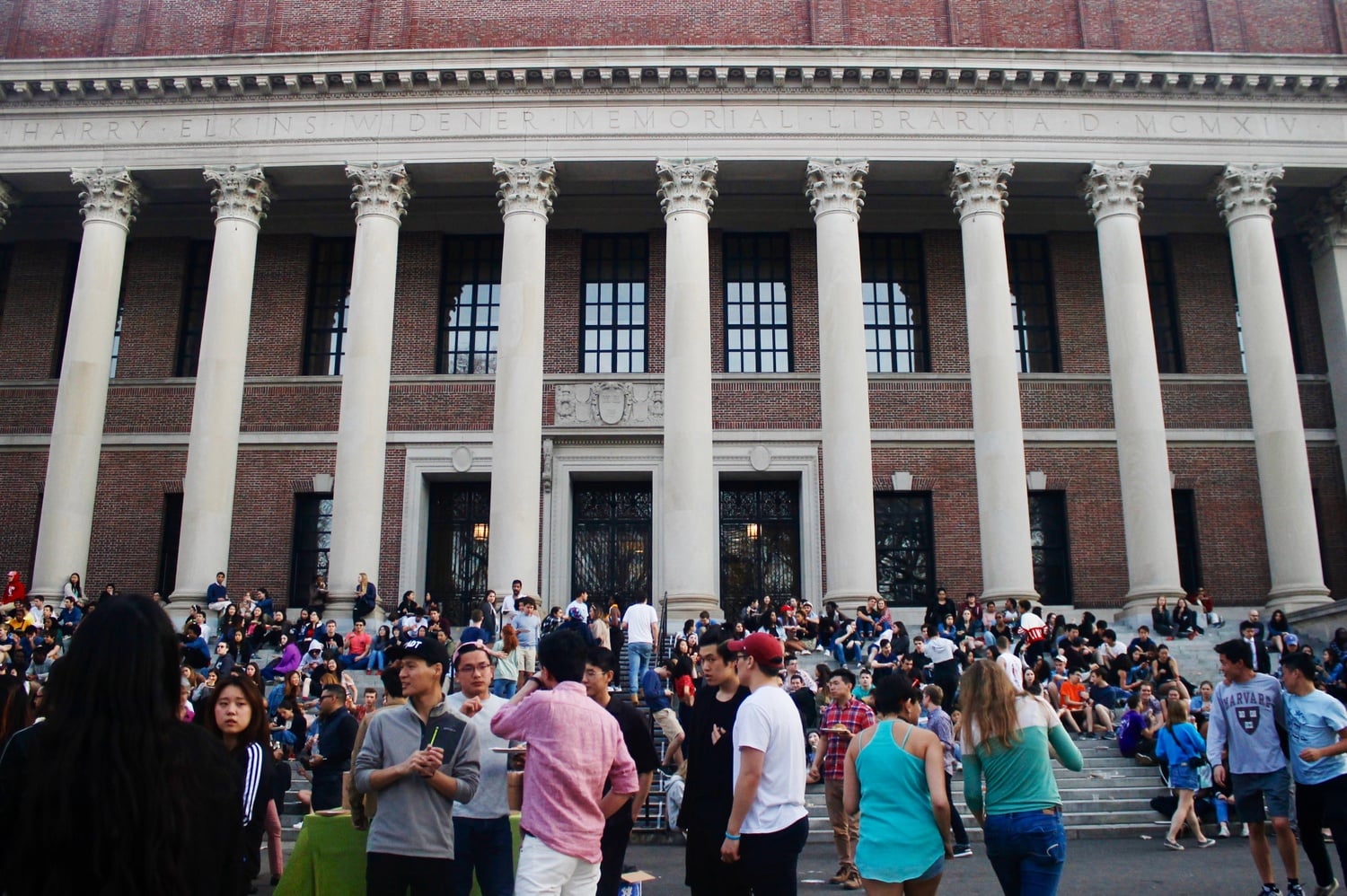 Students enjoy the balmy weather Friday afternoon during Yardfest. Food and drinks were provided at the event and many students ate outside on the steps of Widener Library.