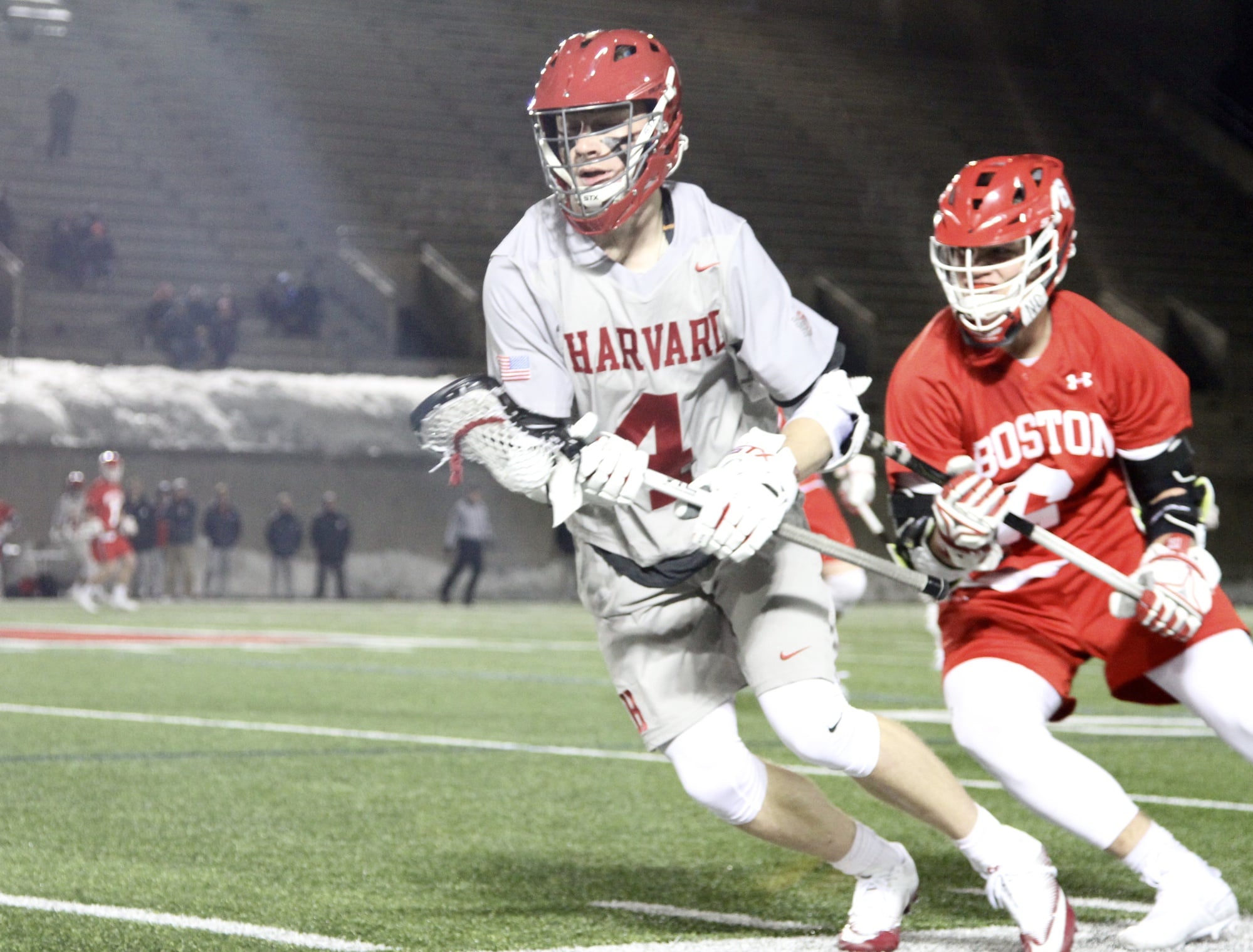 Freshman Charlie Olmert cradles the ball and turns upfield in a recent contest against Boston University.