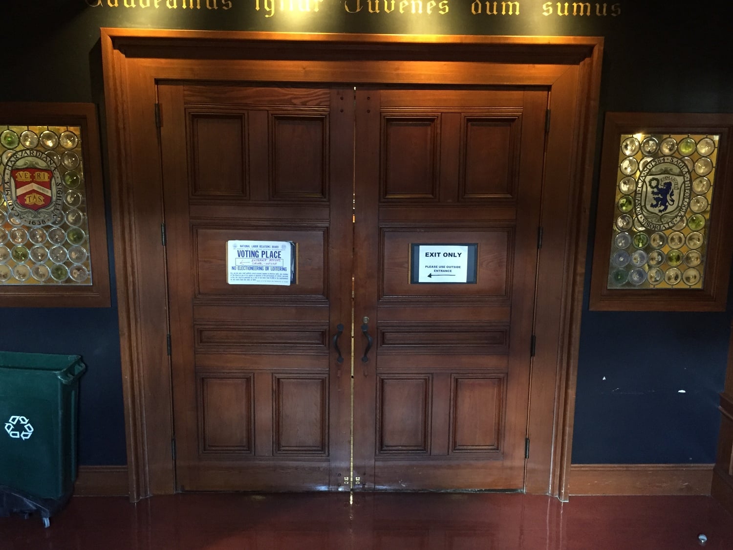 Doors conceal the line of voters inside the Queen's Head Pub during the first day of voting in Harvard's second unionization election.