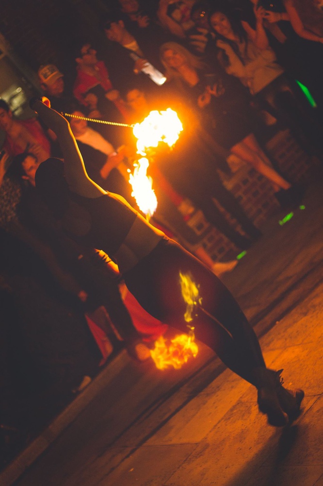 Ann H. "Annie" Opel spins poi at a Spee Club party.