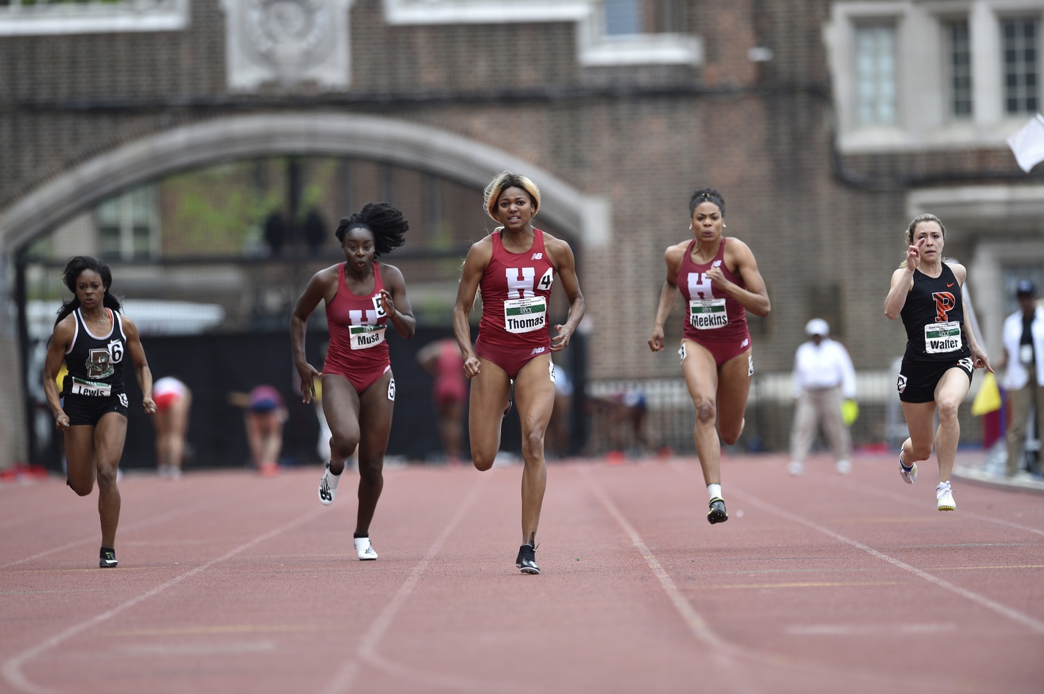 Junior co-captain Gabby Thomas, flanked by classmate Ngozi Musa (left) and sophomore Micah Meekins (right), compete in the 100-meter dash in the first qualifying heat on Saturday. All three advanced to the final race on Sunday.