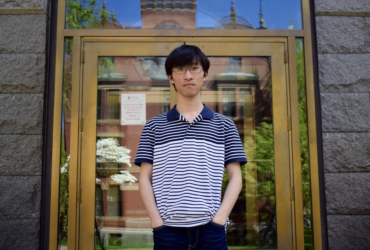 Yueran Zhang, a PhD student in Sociology and a supporter of the union, stands outside Boylston Hall. 