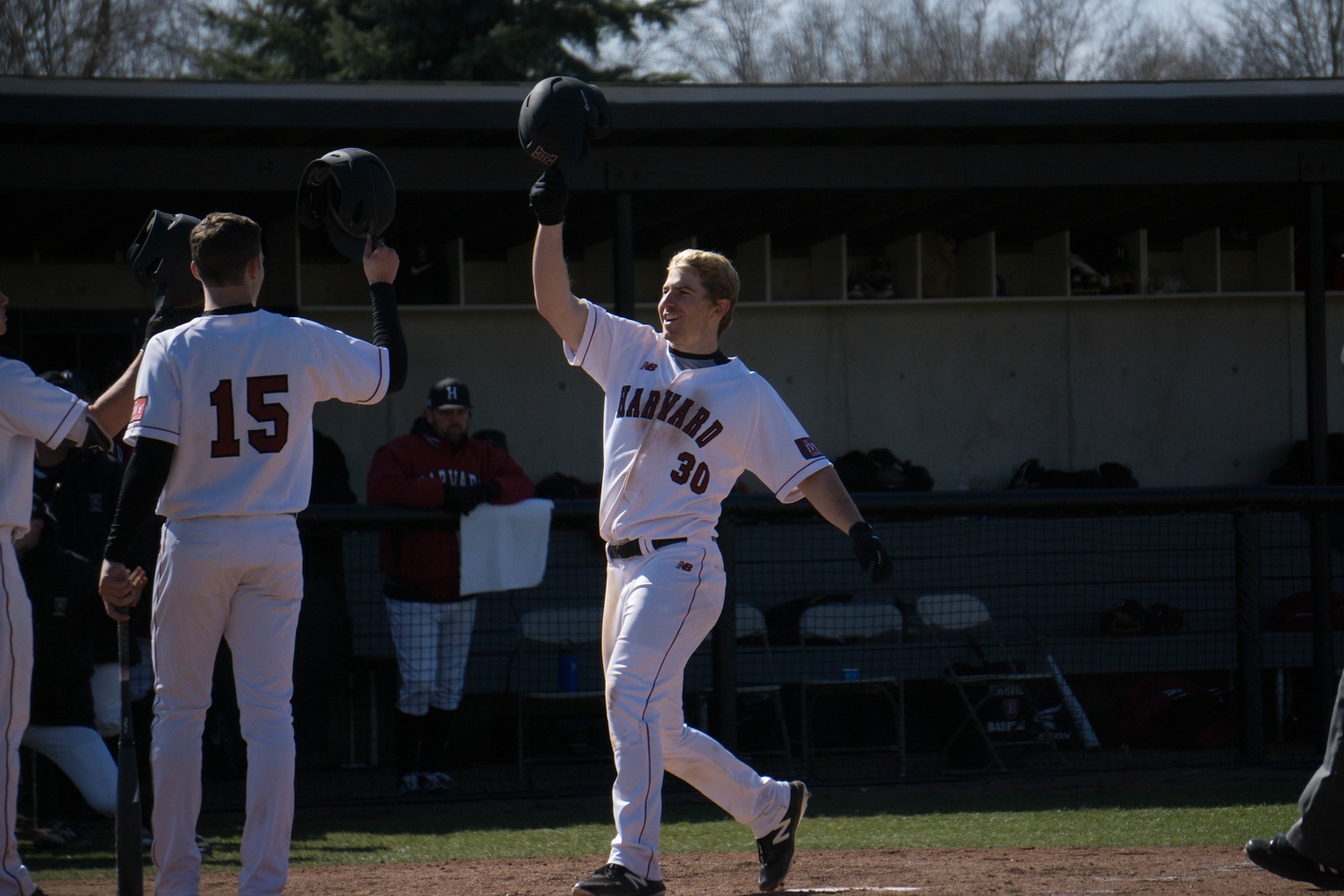 Sophomore Hunter Bigge and senior Austin Black celebrate at the plate against Penn on April 7. The two have been important bats for the Crimson in the middle of the lineup this season.