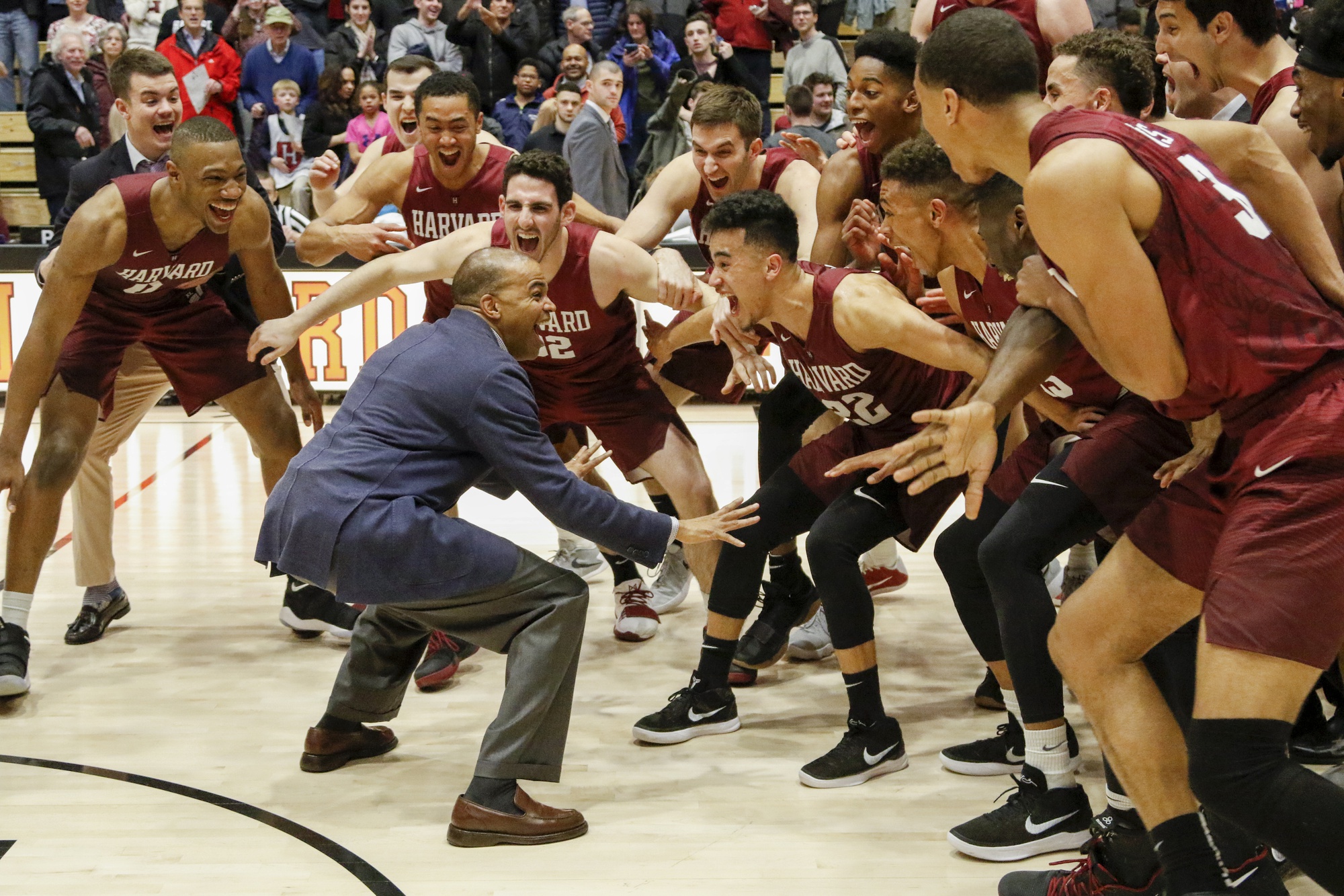 Head coach Tommy Amaker stands in front of his team following Harvard’s 93-74 win against Columbia this season. The win gives the Crimson its sixth Ivy League title in eight years. 