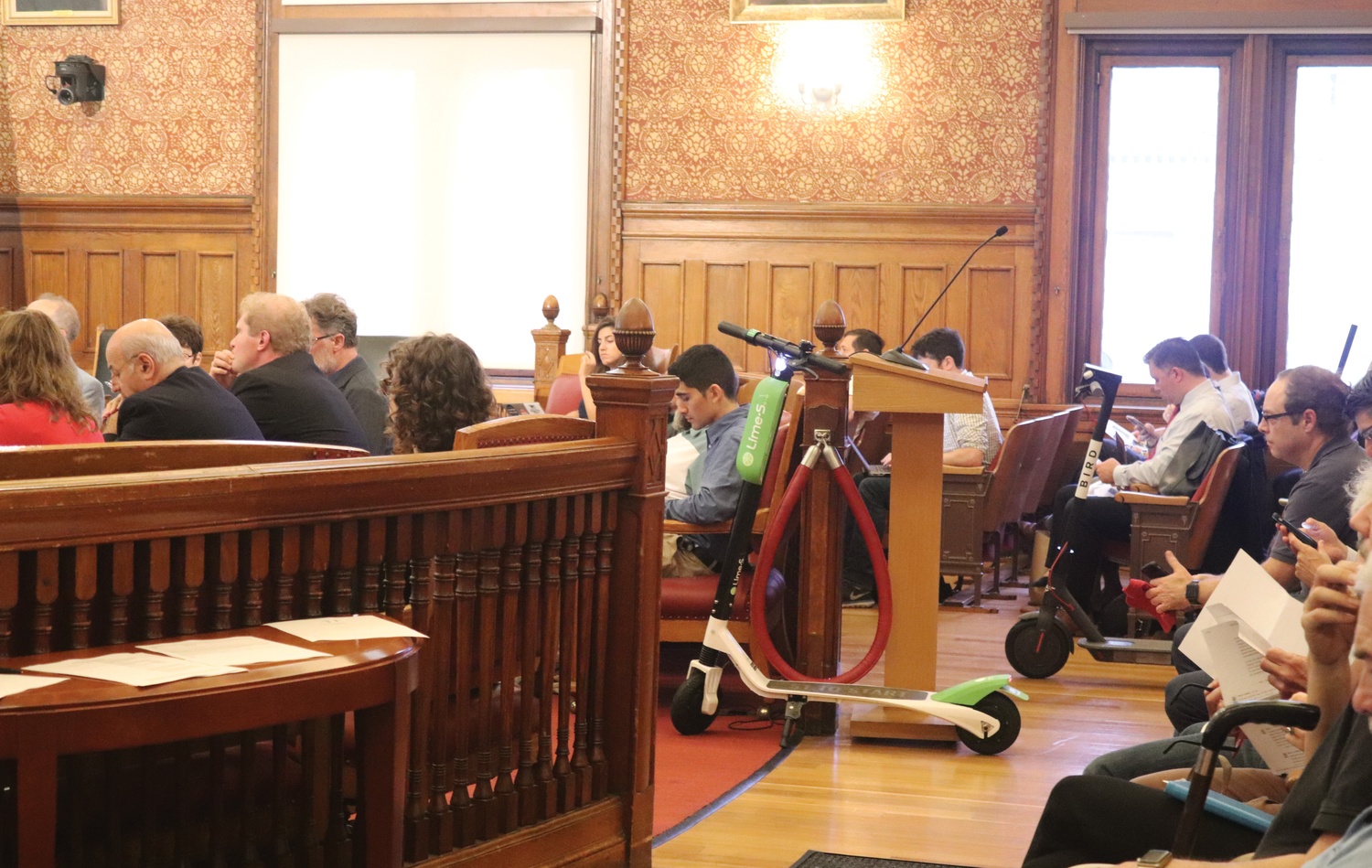 Representatives from electric scooter companies Bird and LimeBike attended a public hearing held by city officials to discuss a possible pilot scooter program.