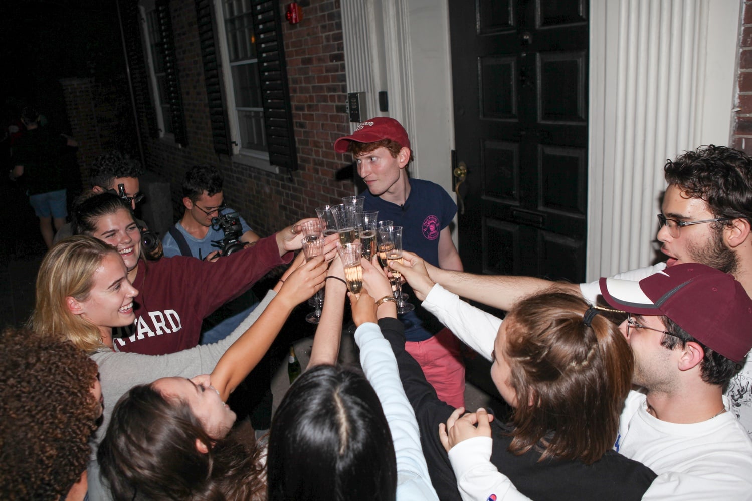 The new cast of the Hasty Pudding celebrates on Dunster Street shortly after the group admitted women as cast members for the first time in its nearly 200-year history.