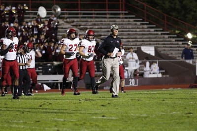 Cover image for In Photos: Football Battles Brown Under Friday Night Lights