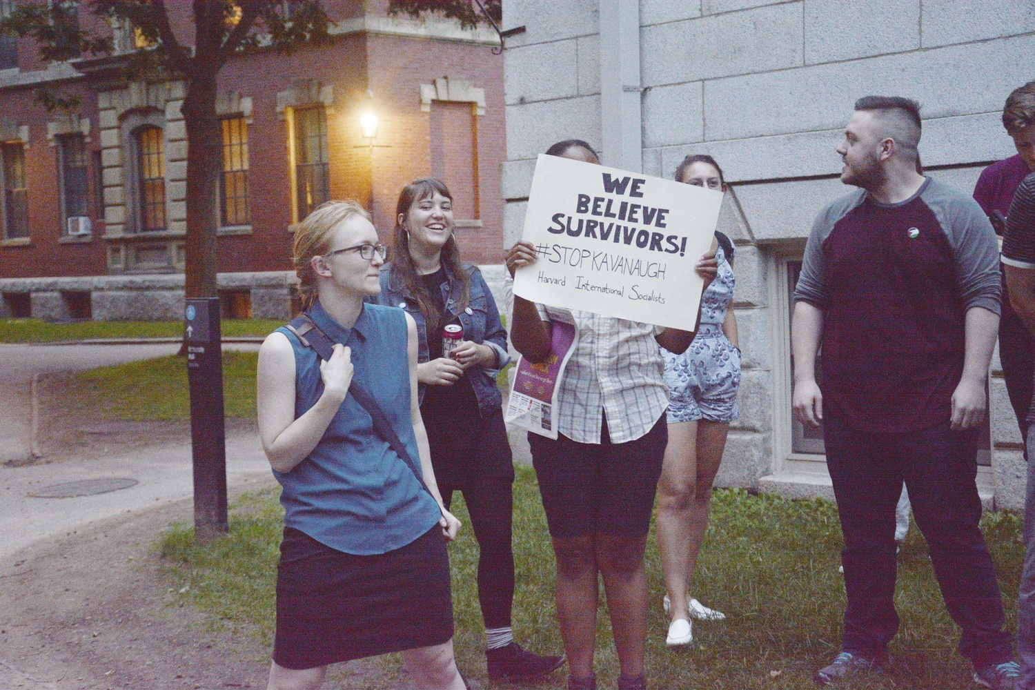 Activists rally against Supreme Court nominee Brett M. Kavanaugh by the John Harvard statue on Wednesday.