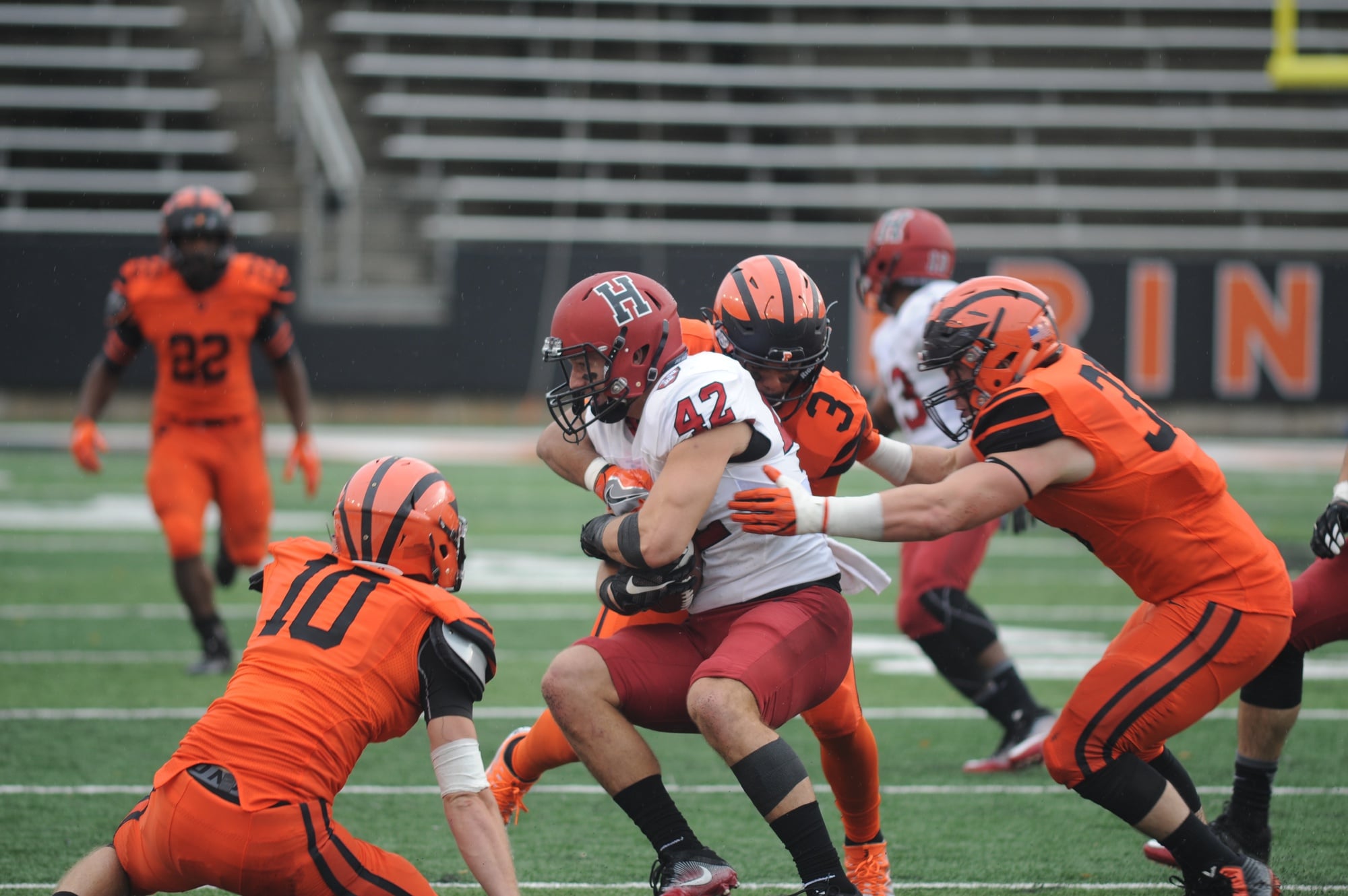 Anthony Firkser '17 battles through a group of Princeton defenders after making a catch. The former tight end is one of nine Harvard players currently on NFL rosters.