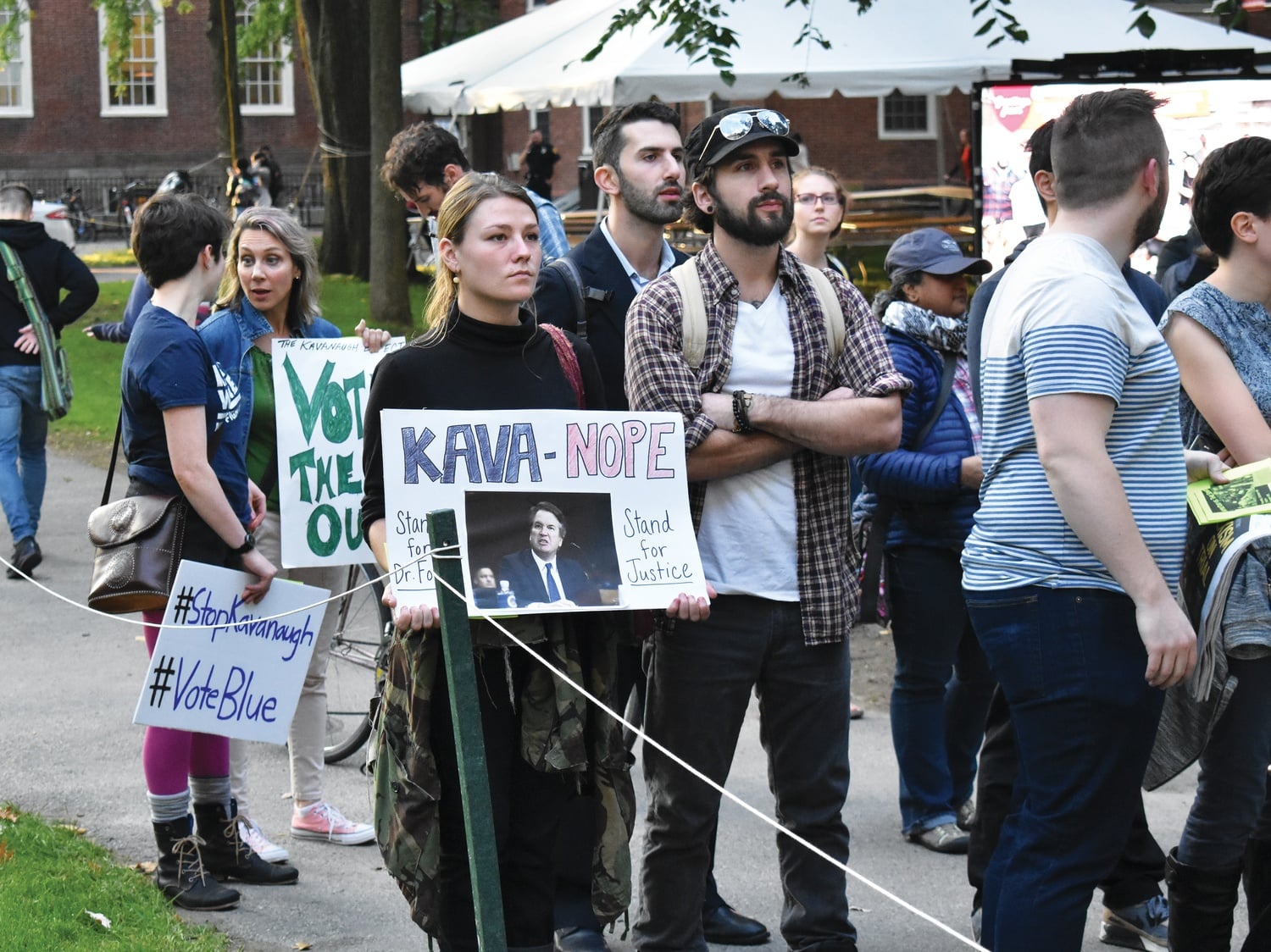 The Harvard International Socialists hold a rally against the appointment of Brett M. Kavanaugh to the Supreme Court in front of the John Harvard Statue.