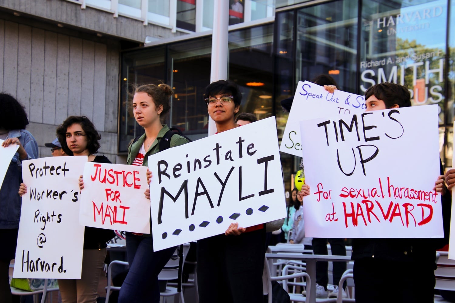 Protesters stand outside Smith Campus Center on the day of President Bacow's inauguration to advocate for former HUHS employee Mayli Shing.