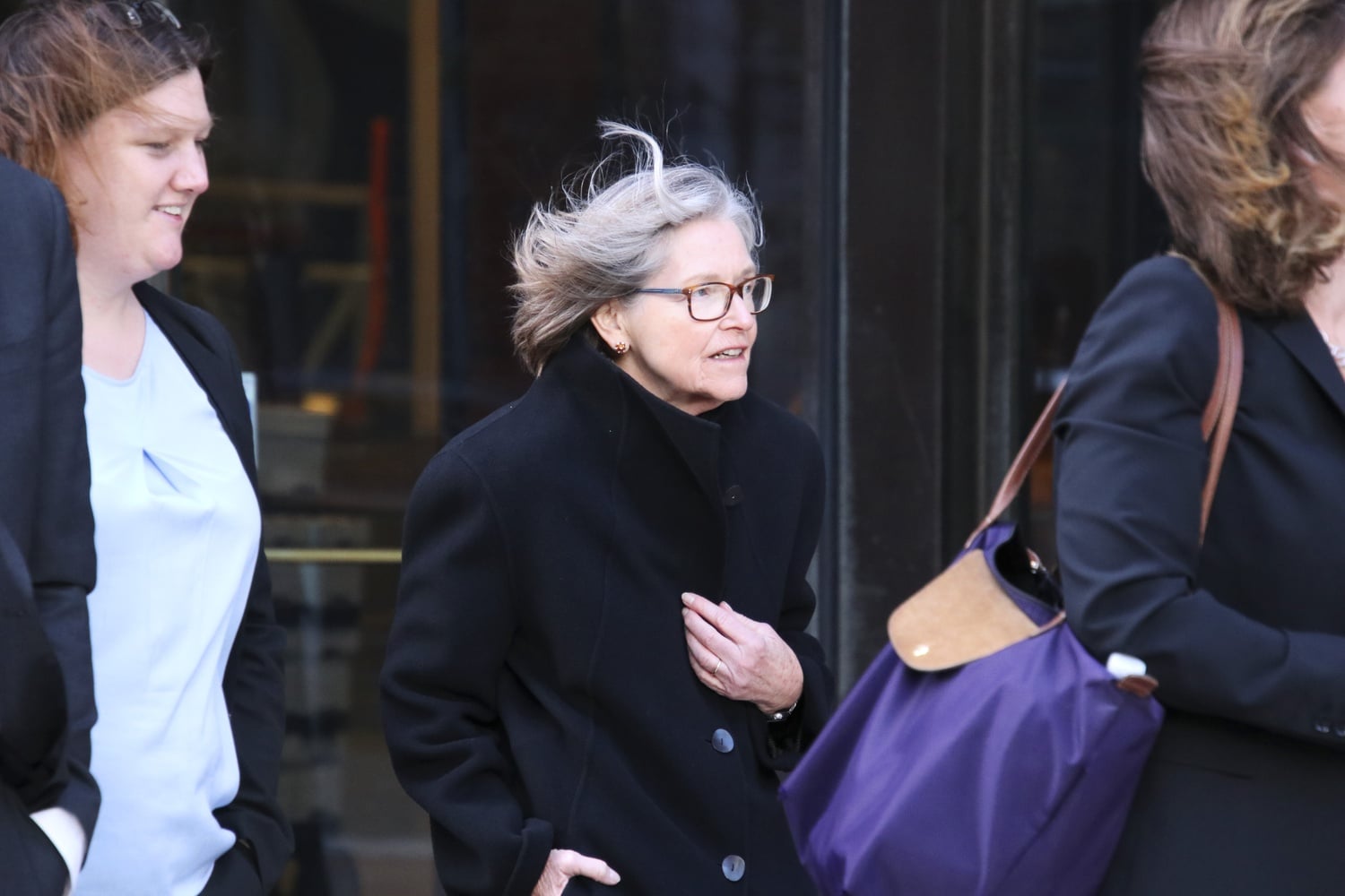 Marlyn E. McGrath '70, Harvard's director of admissions, exits the courthouse Friday.