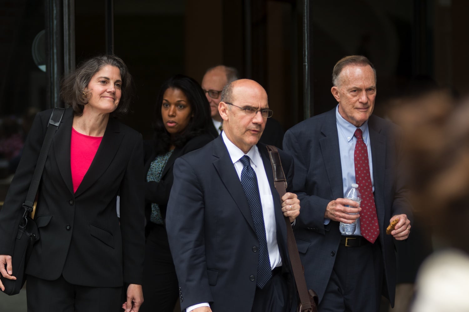 Harvard's long-serving Dean of Admissions and Financial Aid William R. Fitzsimmons '67 (far right) exits the courthouse during the admissions trial.