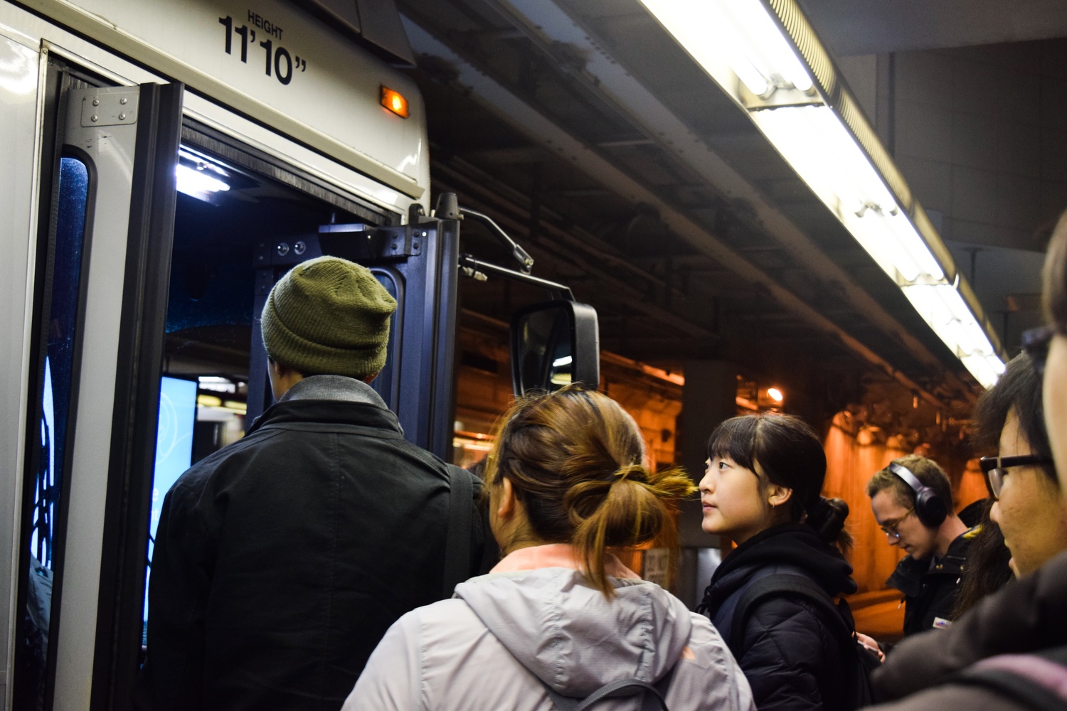 Students board the T early Monday morning to ride to the courthouse to support their peers testifying in the Harvard admissions trial. Harvard's Task Force on Asian and Pacific American Studies organized the group trip.