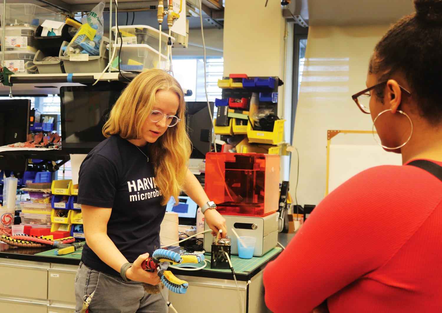 Kaitlyn P. Becker, a graduate engineering student who works on robotics, shows a group of visiting incarcerated youth how her gadgets work.